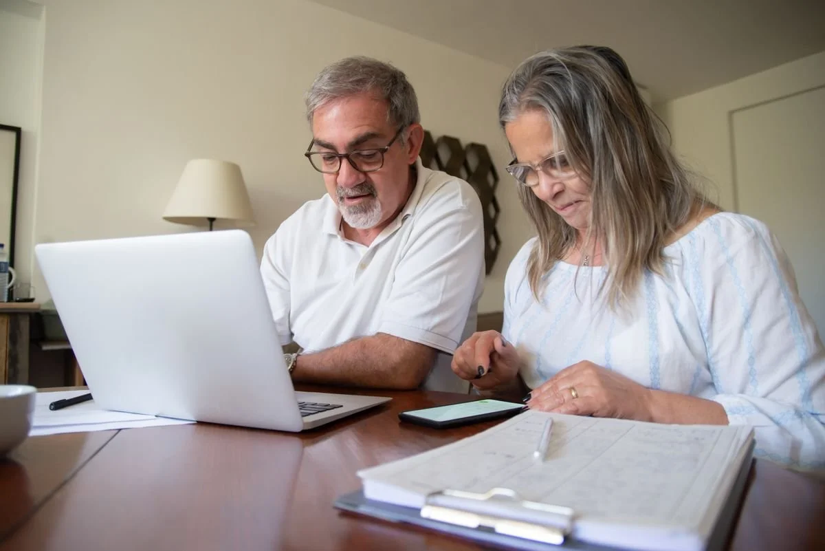 A couple going over their finances together at a desk