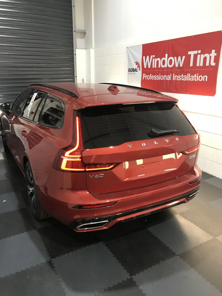 Red car with rear tints near Lincoln
