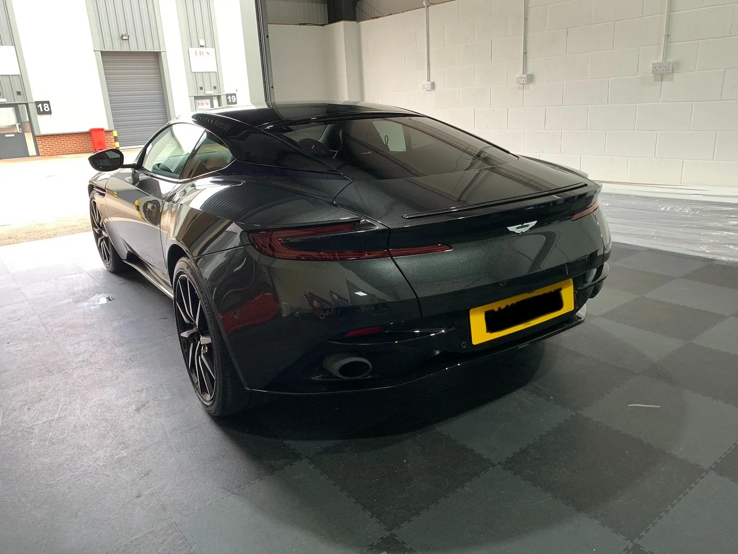 Black luxury sports car with freshly tinted rear windows at the Direct Window Tints workshop in Lincoln