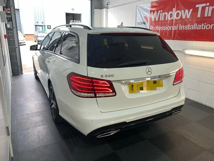 White car with rear tints near Lincoln