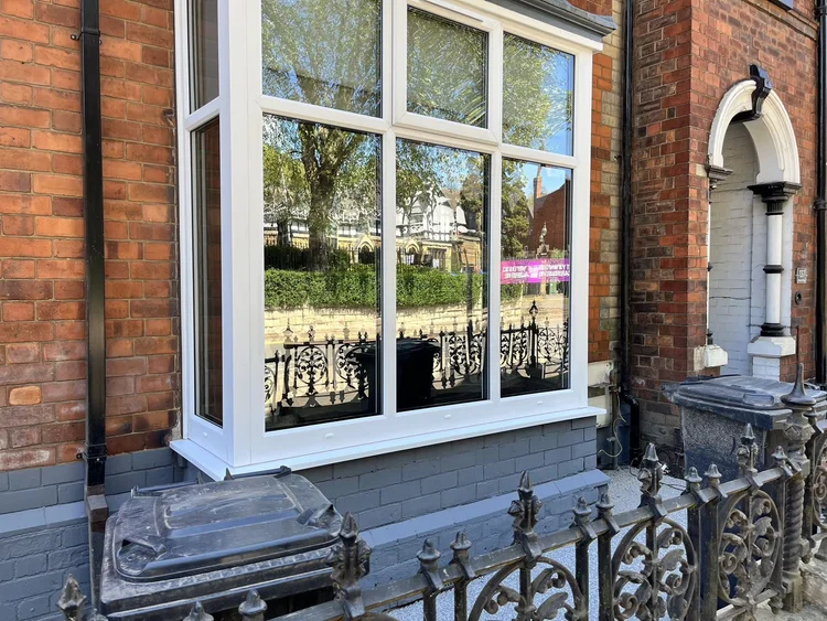 Large white-framed window on a commercial building