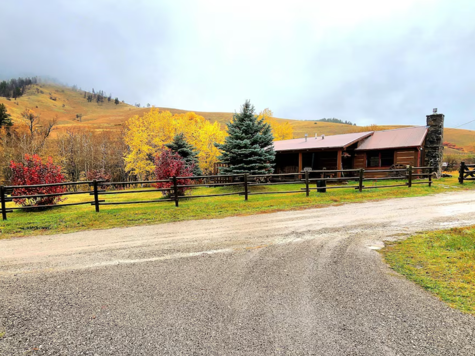 Cabin lodge tucked behind fall trees