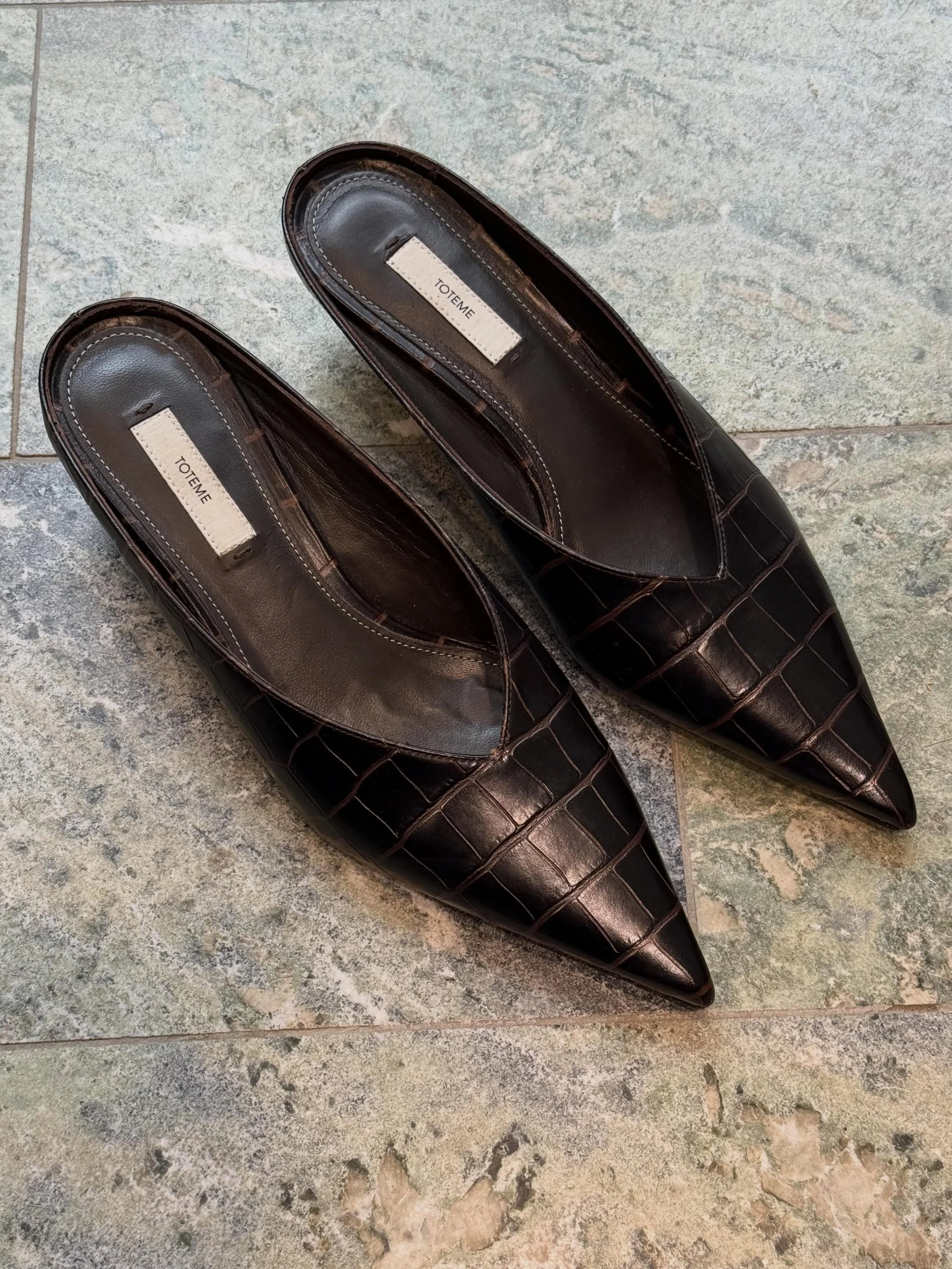The Sharp Croco Embossed Wedge Mule from TOTEME balances the sharp femininity with sculptural minimalism we know and love the Swedish fashion house for. Designed to elevate your relaxed denims as well as precise tailoring, they are in fact the perfec