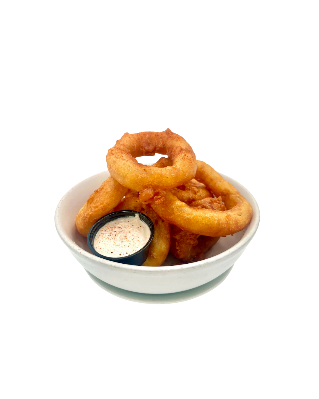 A white bowl with Beer Battered Onion rings and A horseradish cream on a white counter at Franklins Restaurant in Maryland