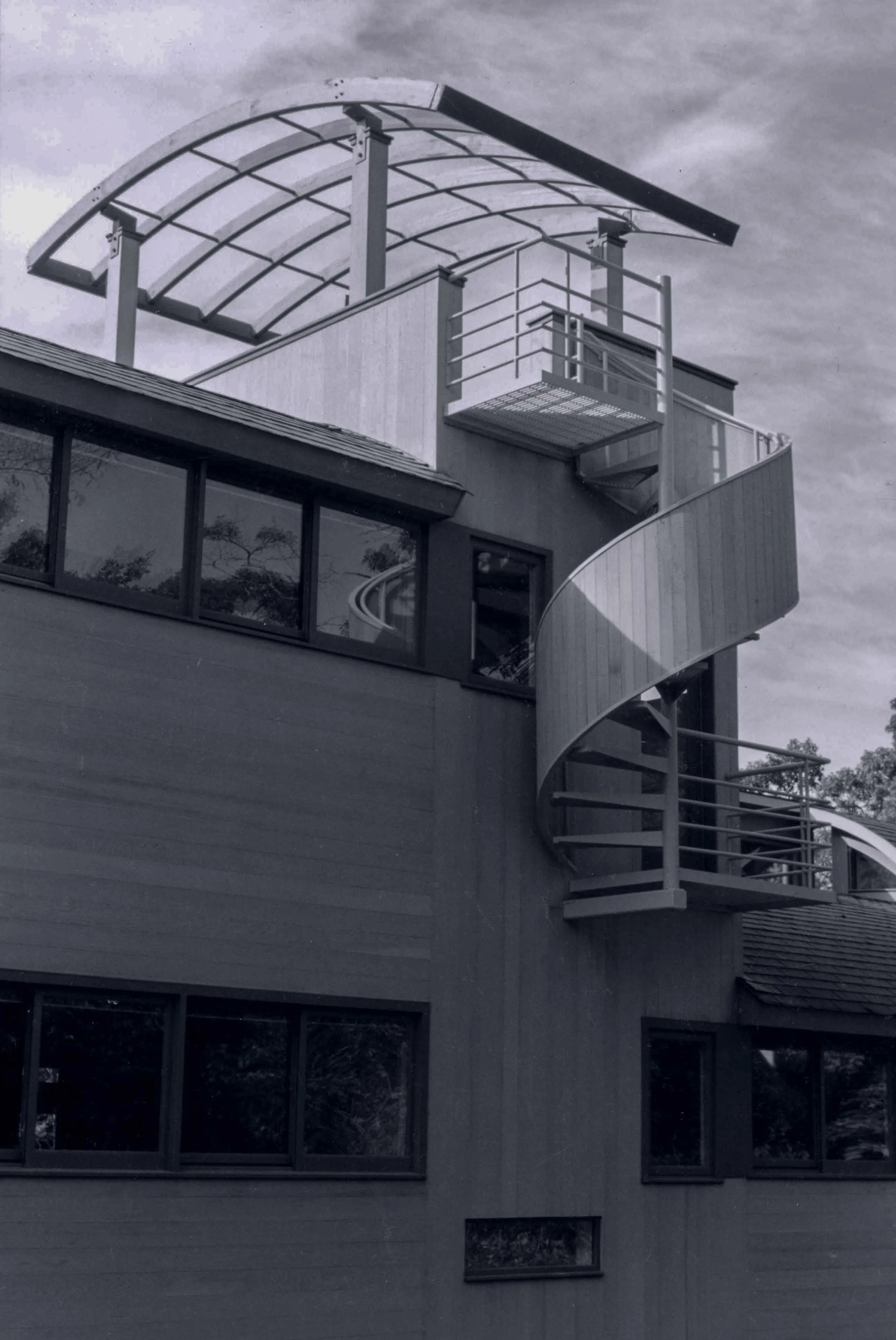 Modern multi-story house with spiral stair to roof deck.