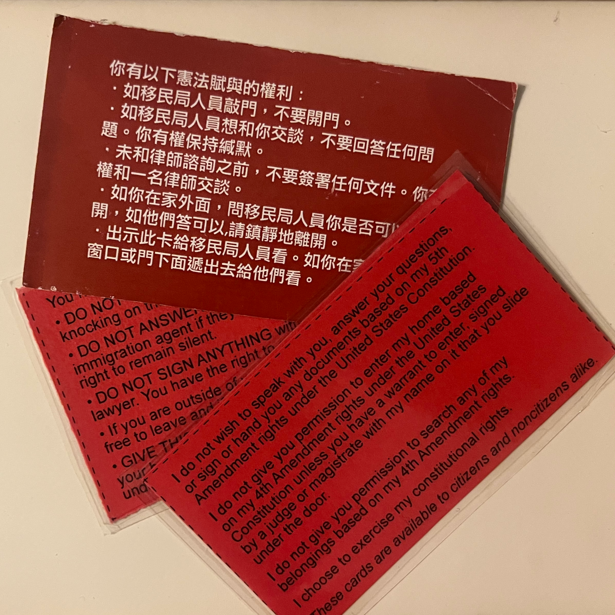 a small pile of different shades of red cards in English and Chinese