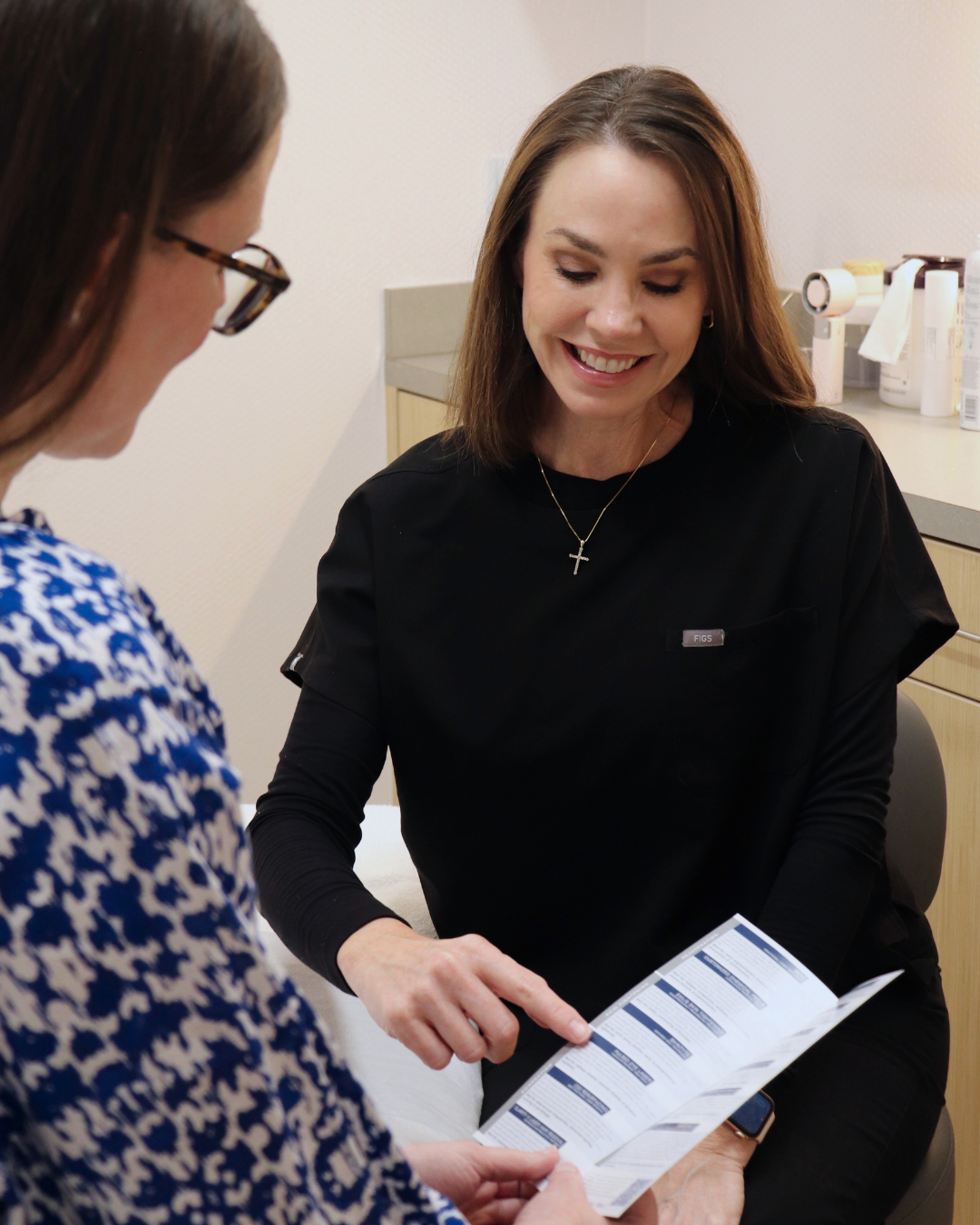 Jen showing information about a chemical peel to a patient