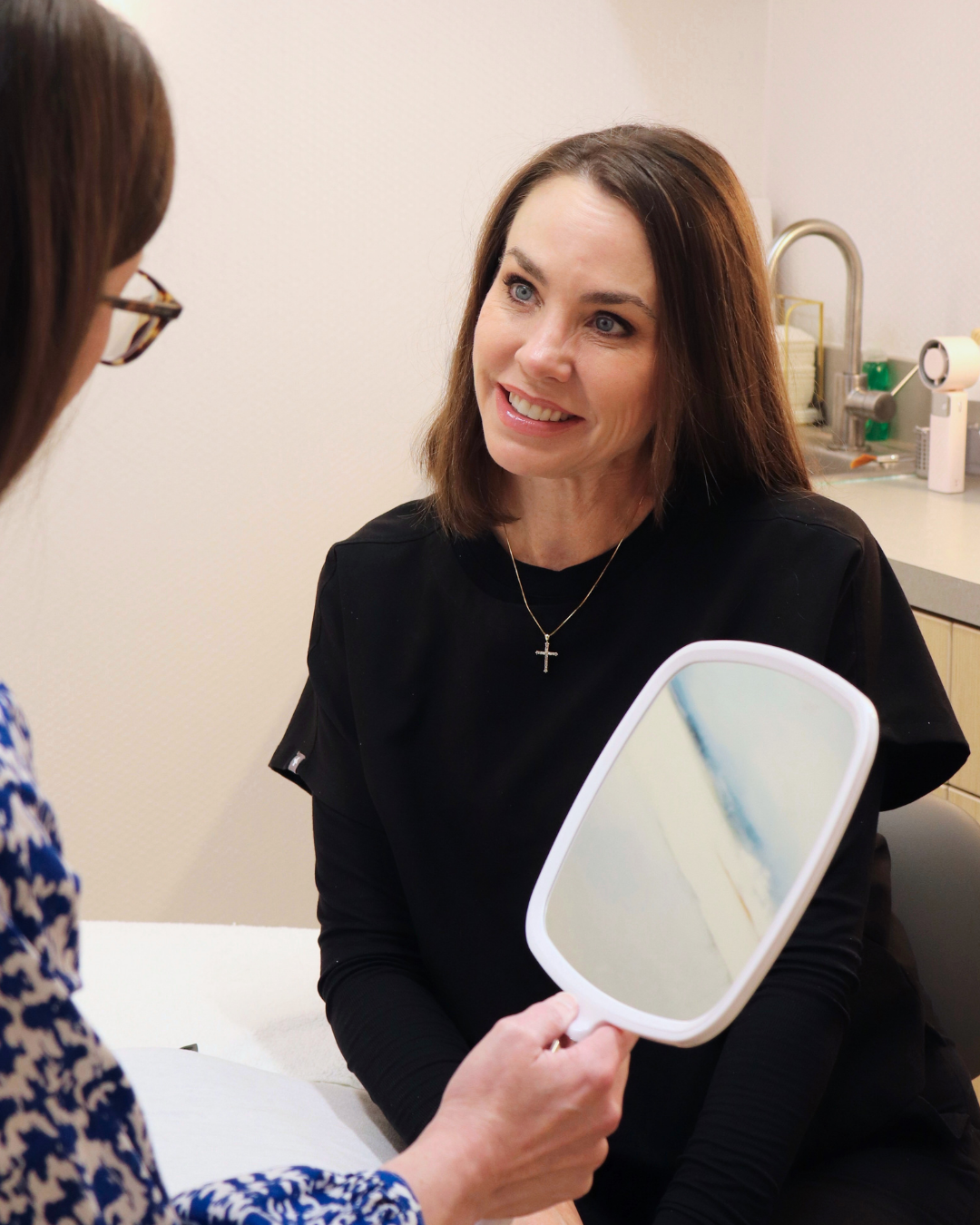 Jen sits with a patient to discuss Acne Scar Treatment solutions at Derma in Baton Rouge
