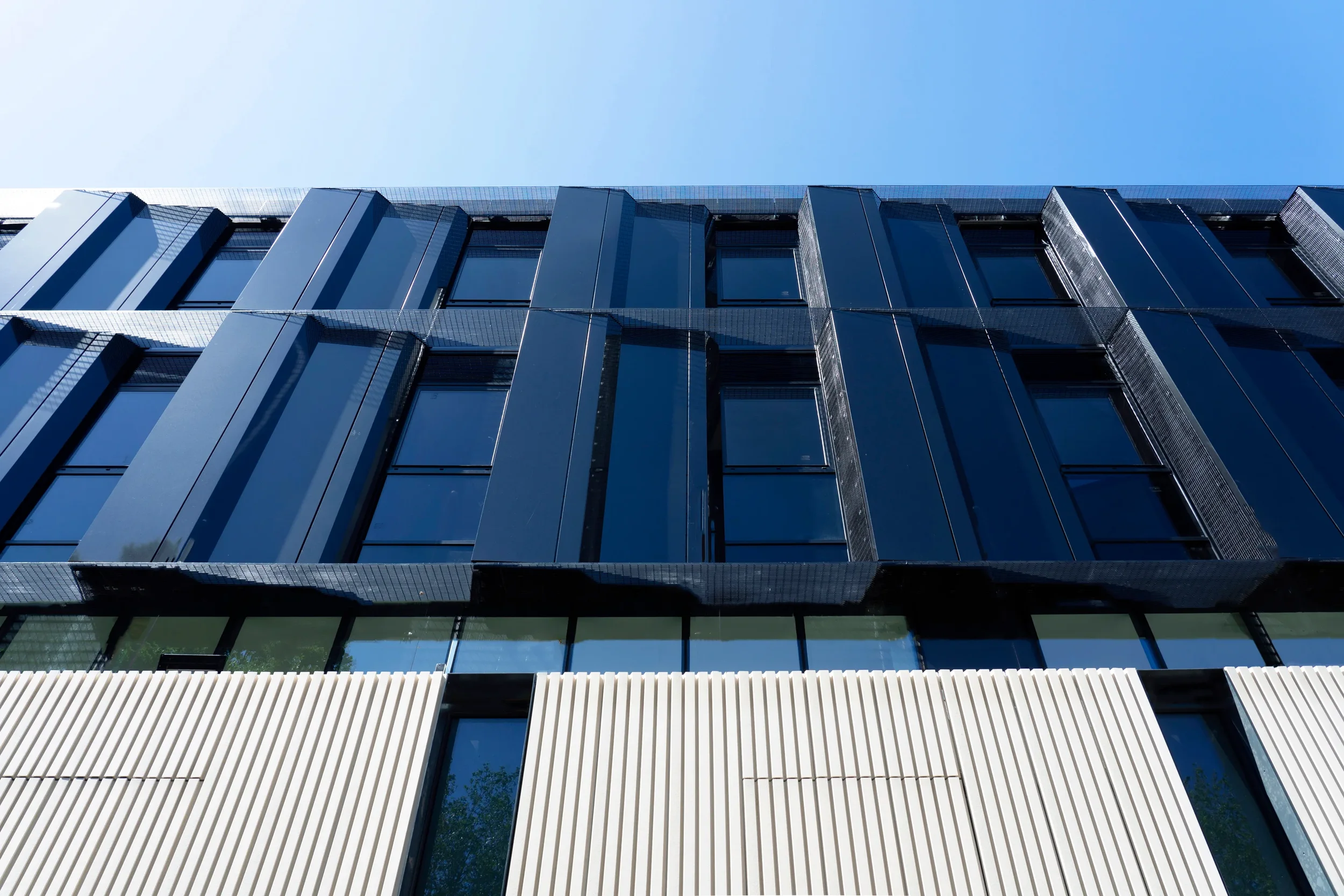 Circle Birmingham Hospital – upper facade detail with dark cladding and mesh brise soleil