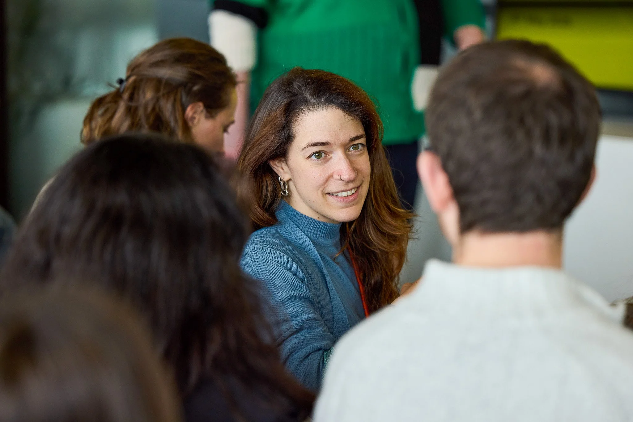 A Bryden Wood team member in conversation at a studio event in London, reflecting the collaborative and people-focused culture of the practice.