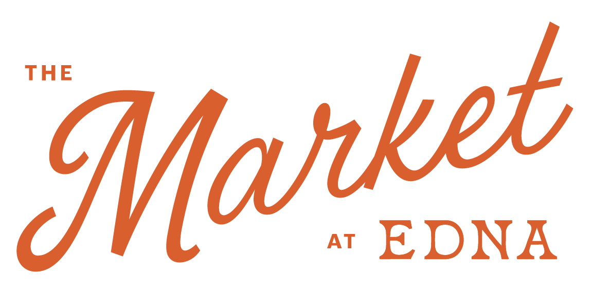 The logo for 'The Market at EDNA' with the word 'Market' in large cursive font and orange color, and smaller text 'The' and 'at EDNA' in uppercase and orange.