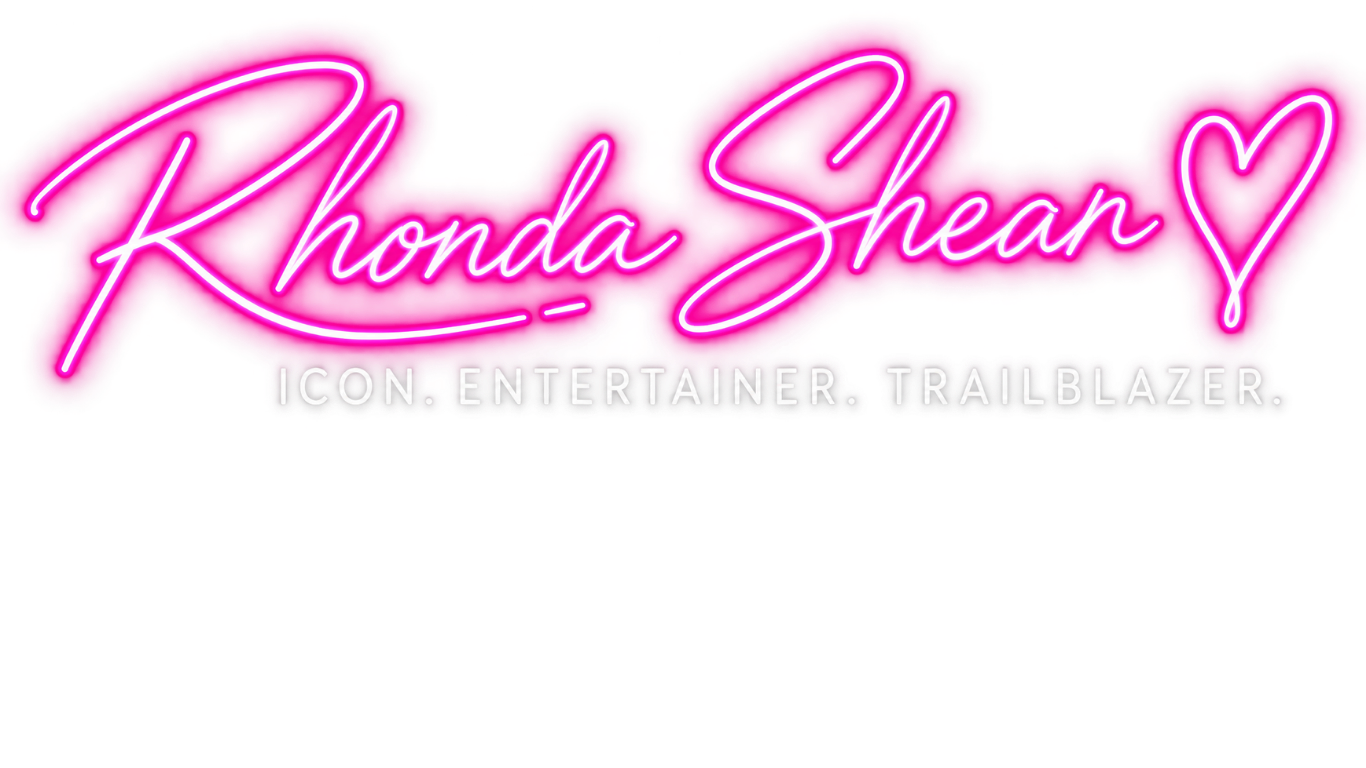 Neon sign with the name 'Rhonda Shear' in pink cursive font and the words 'ICON ENTERTAINER TRAILBLAZER' in white uppercase letters below.