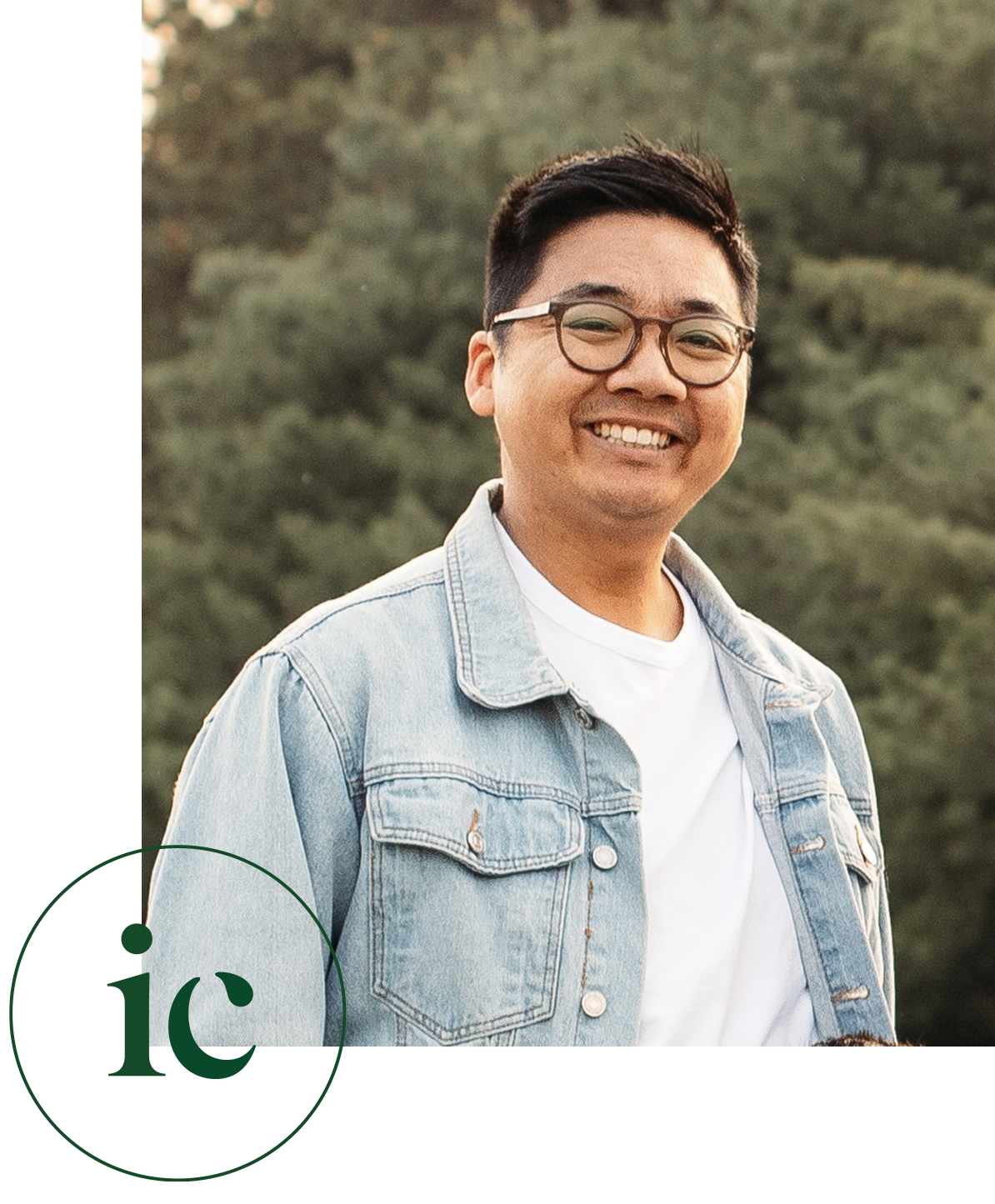 Iven Chung, registered psychotherapist in Kitchener-Waterloo, smiling outdoors in a denim jacket, conveying a warm and approachable demeanour.