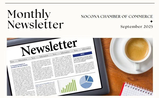 A newsletter titled 'Monthly Newsletter' from the Nocona Chamber of Commerce, dated September 2023, next to a tablet displaying a newsletter with charts, a cup of coffee, and a small notepad on a wooden surface.