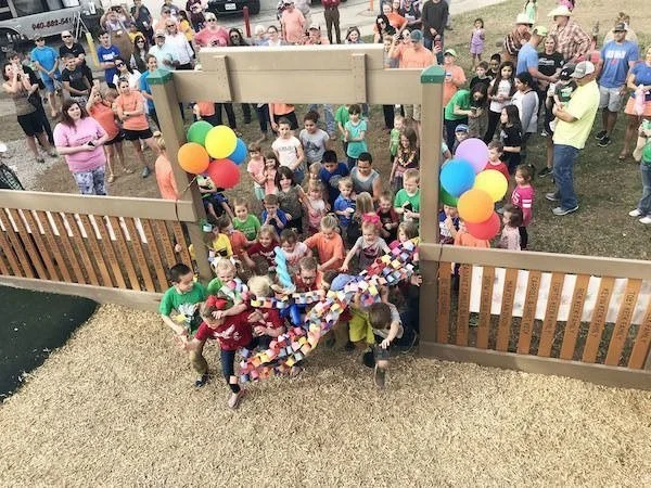 image of throng of kids entering Enid Justin Park for the first time