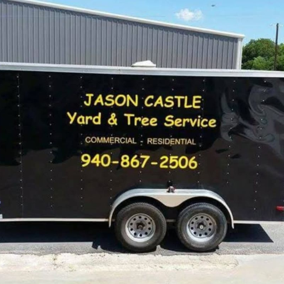 Black trailer with yellow lettering advertising Jason Castle Yard and Tree Service, including phone number 940-867-2506, available for commercial and residential work.