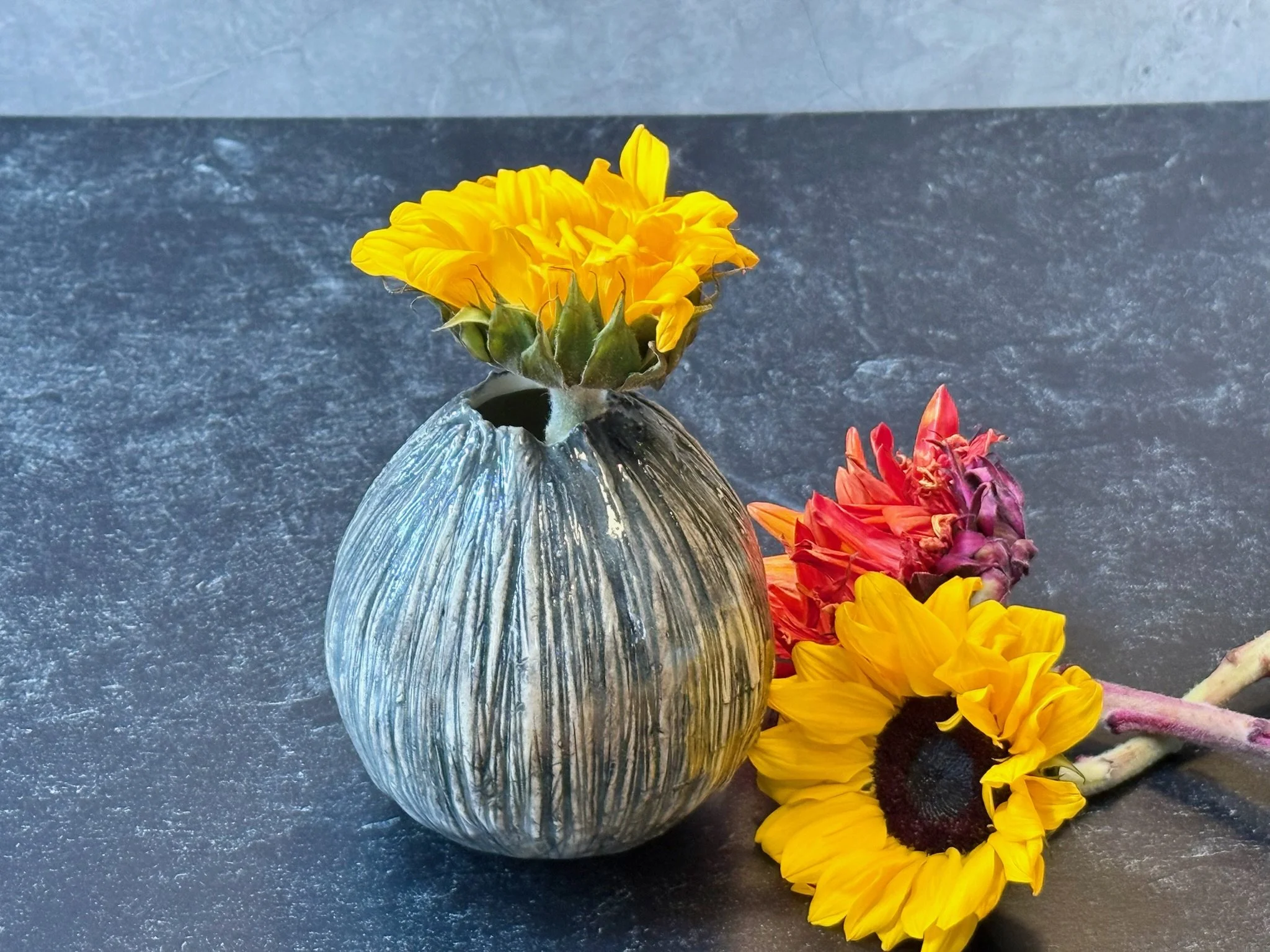Small rounded vase with black oxide under clear gloss and smooth profile.