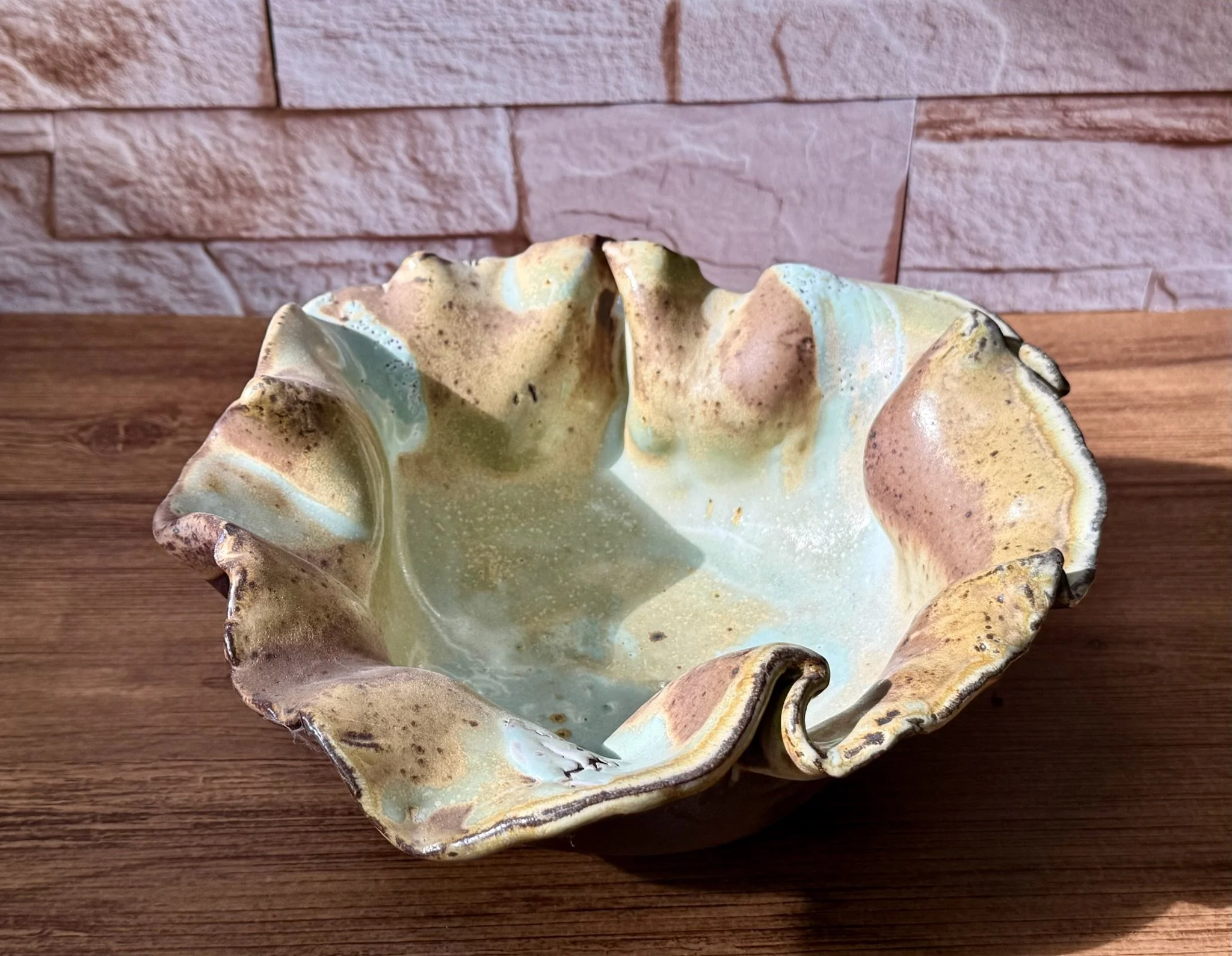 Red stoneware bowl with white slip under salt glaze and reduction-fired depth.