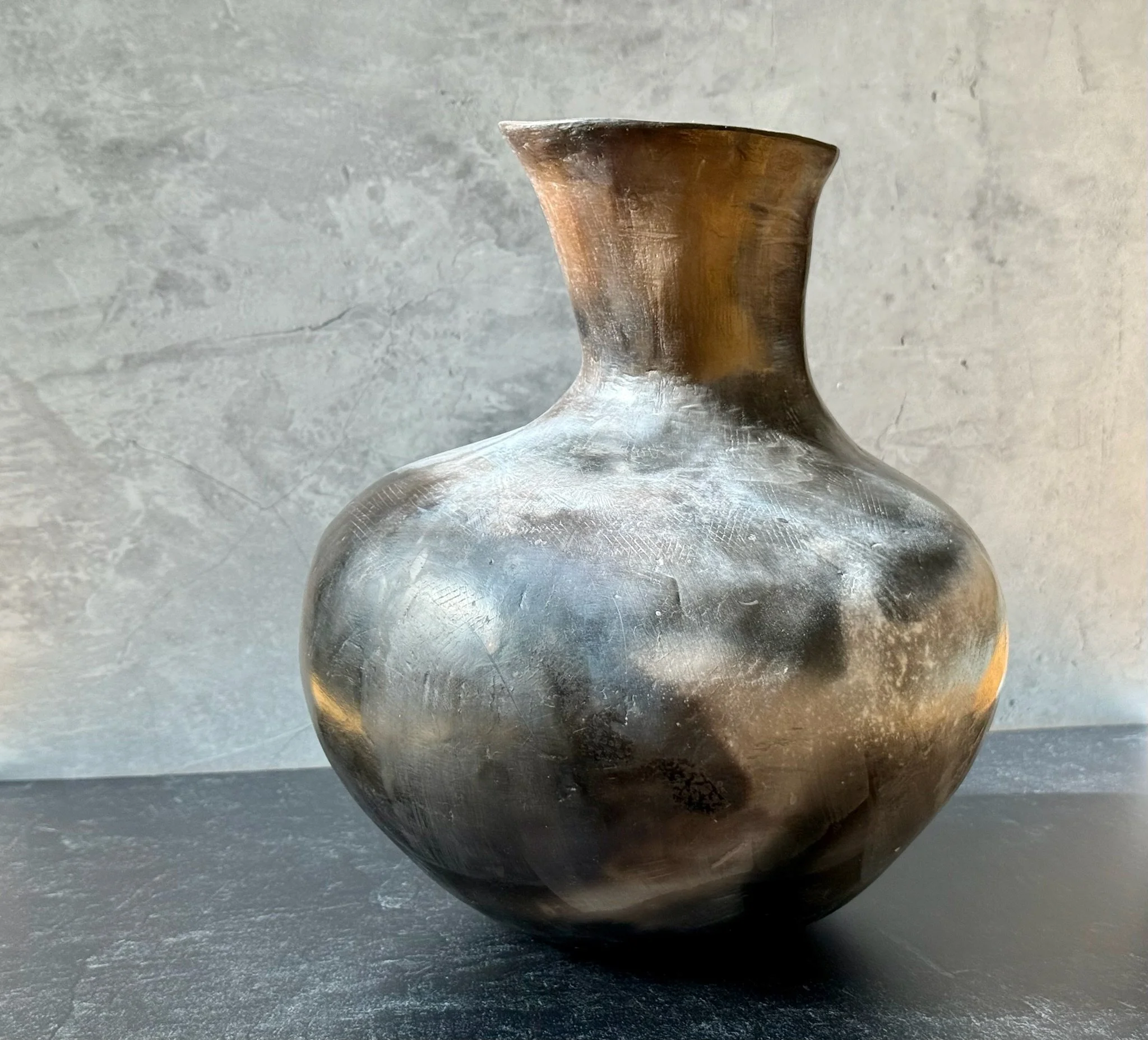 Large white stoneware vase with matte terra sig surface and smoke-fired markings.