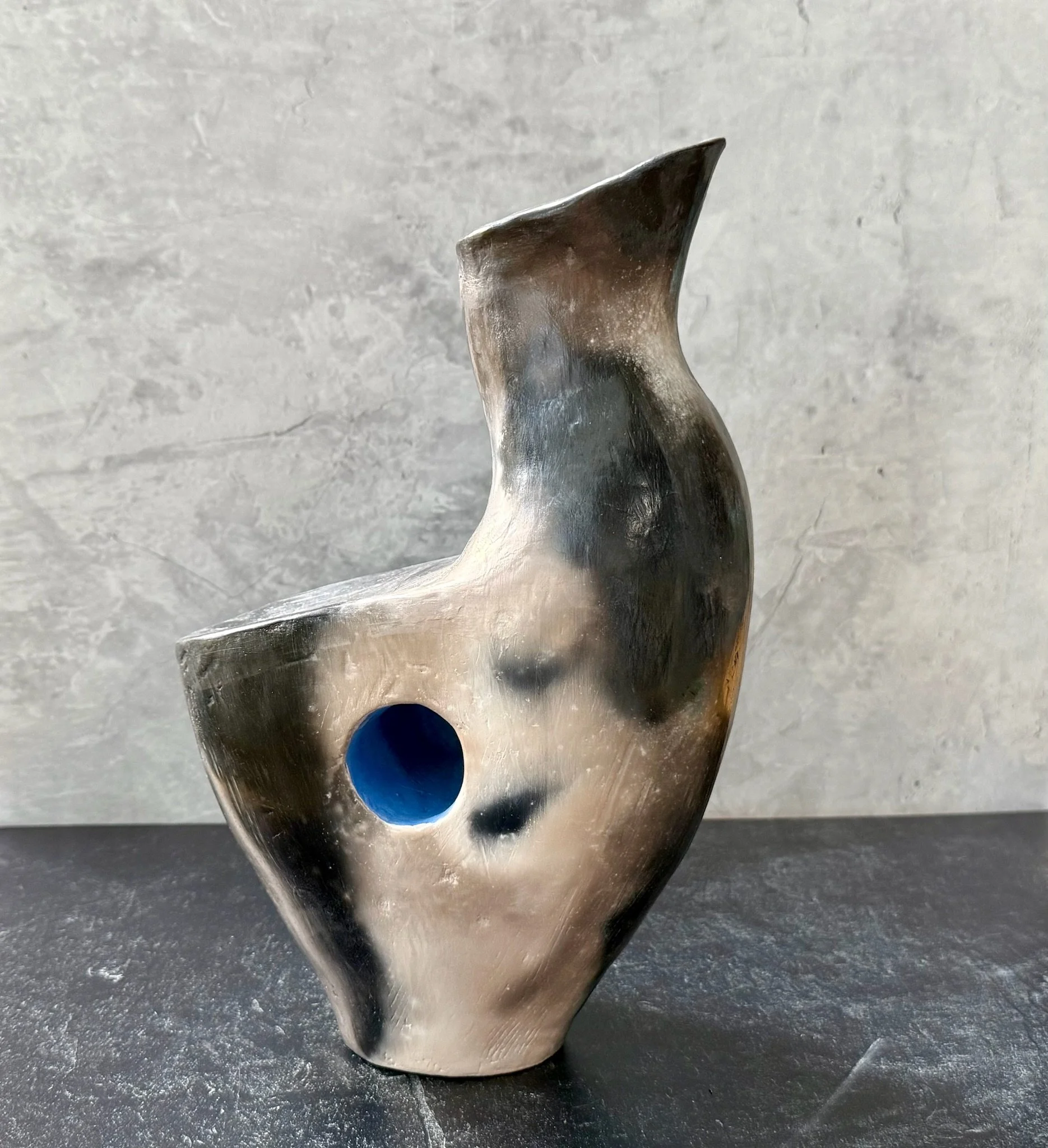 White stoneware vase with terra sig finish, blue accent, subtle smoke-fired markings.
