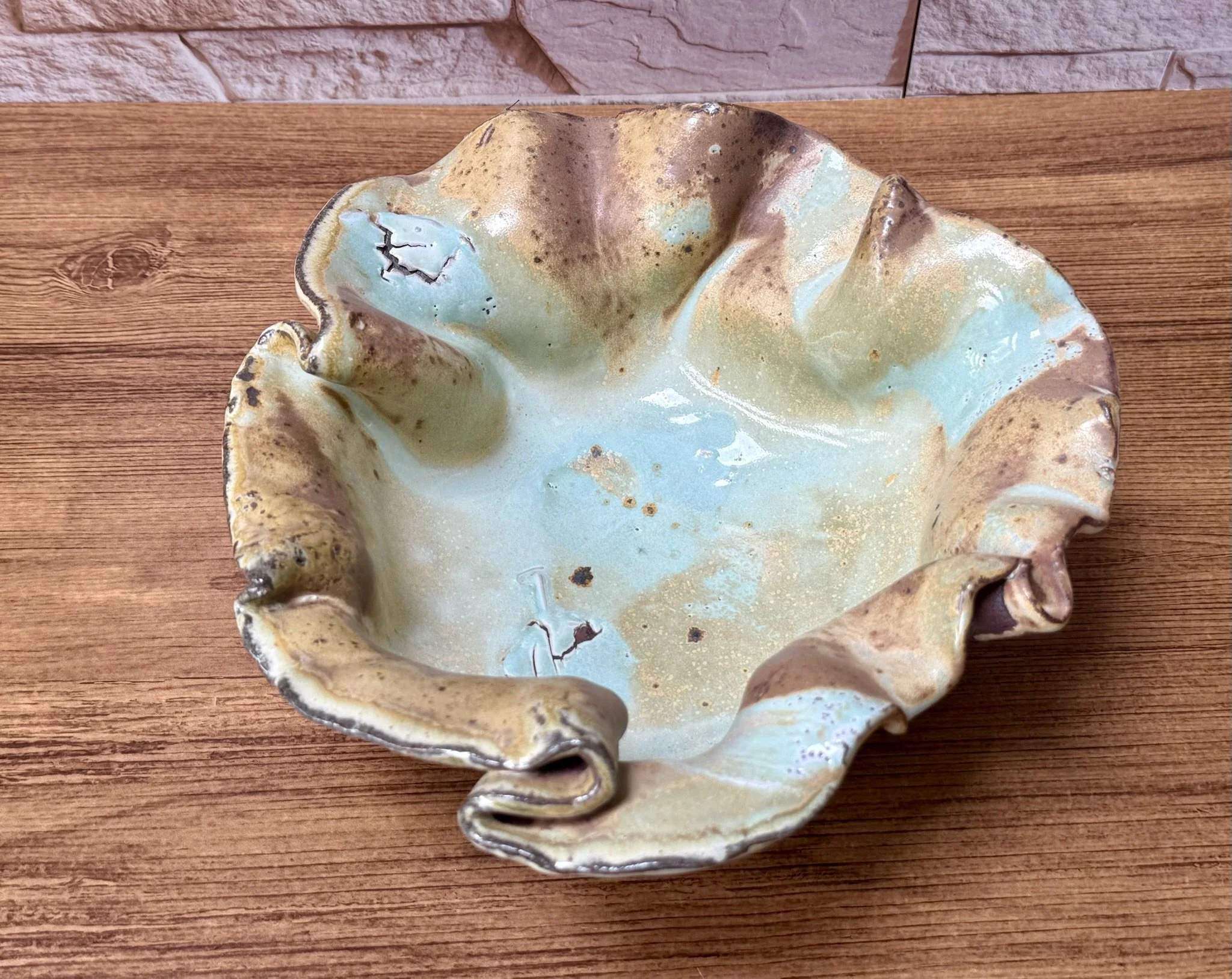 Red stoneware bowl with white slip under salt glaze and reduction-fired depth.