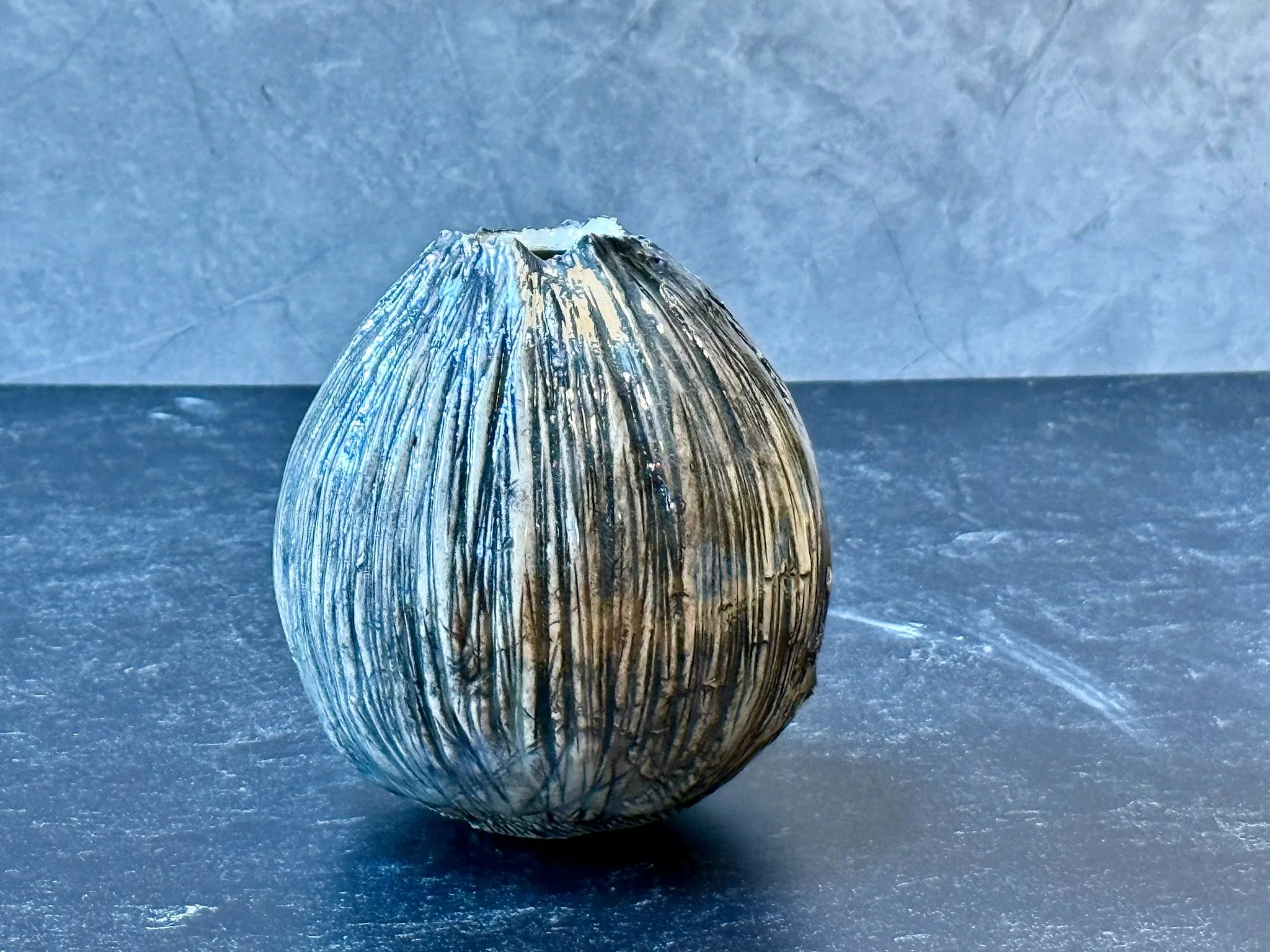 Small rounded vase with black oxide under clear gloss and smooth profile.