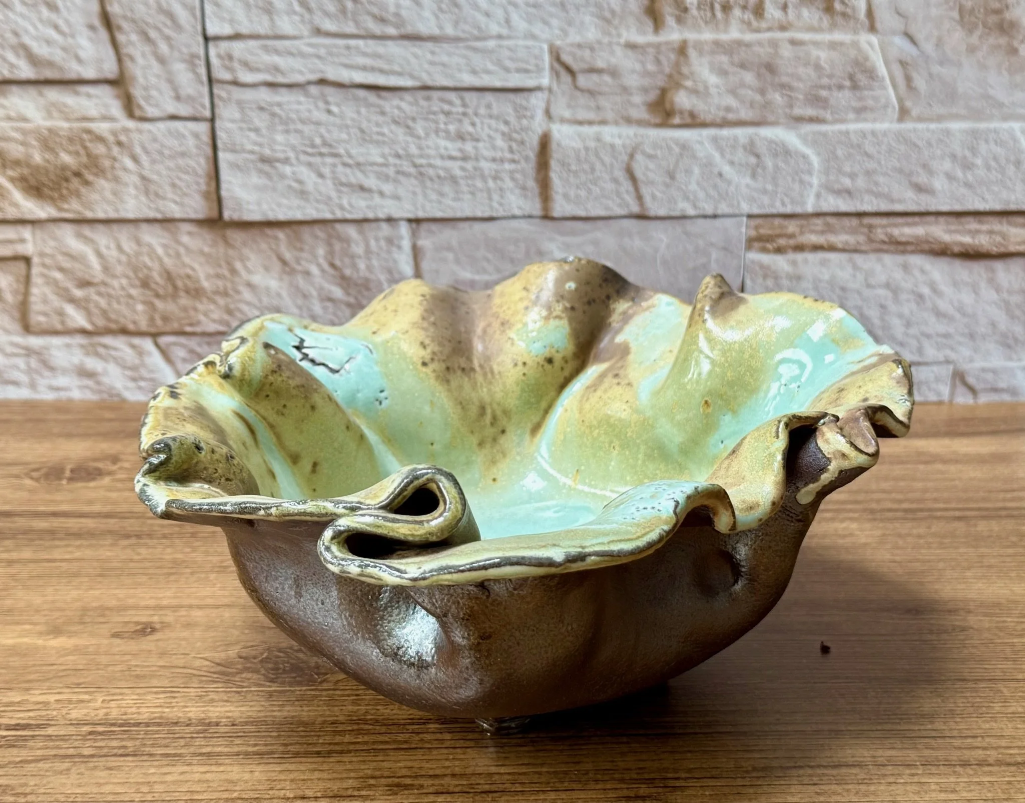 Red stoneware bowl with white slip under salt glaze and reduction-fired depth.