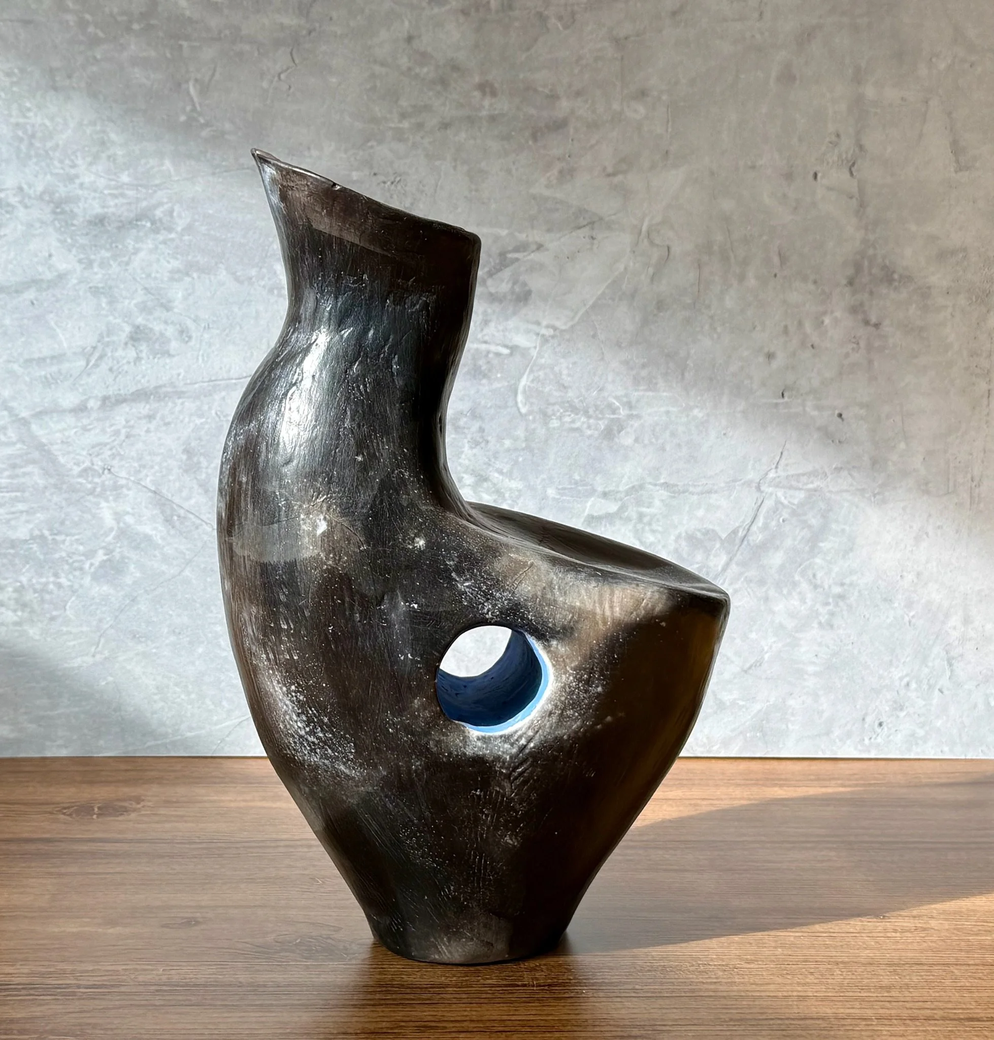 White stoneware vase with terra sig finish, blue accent, subtle smoke-fired markings.