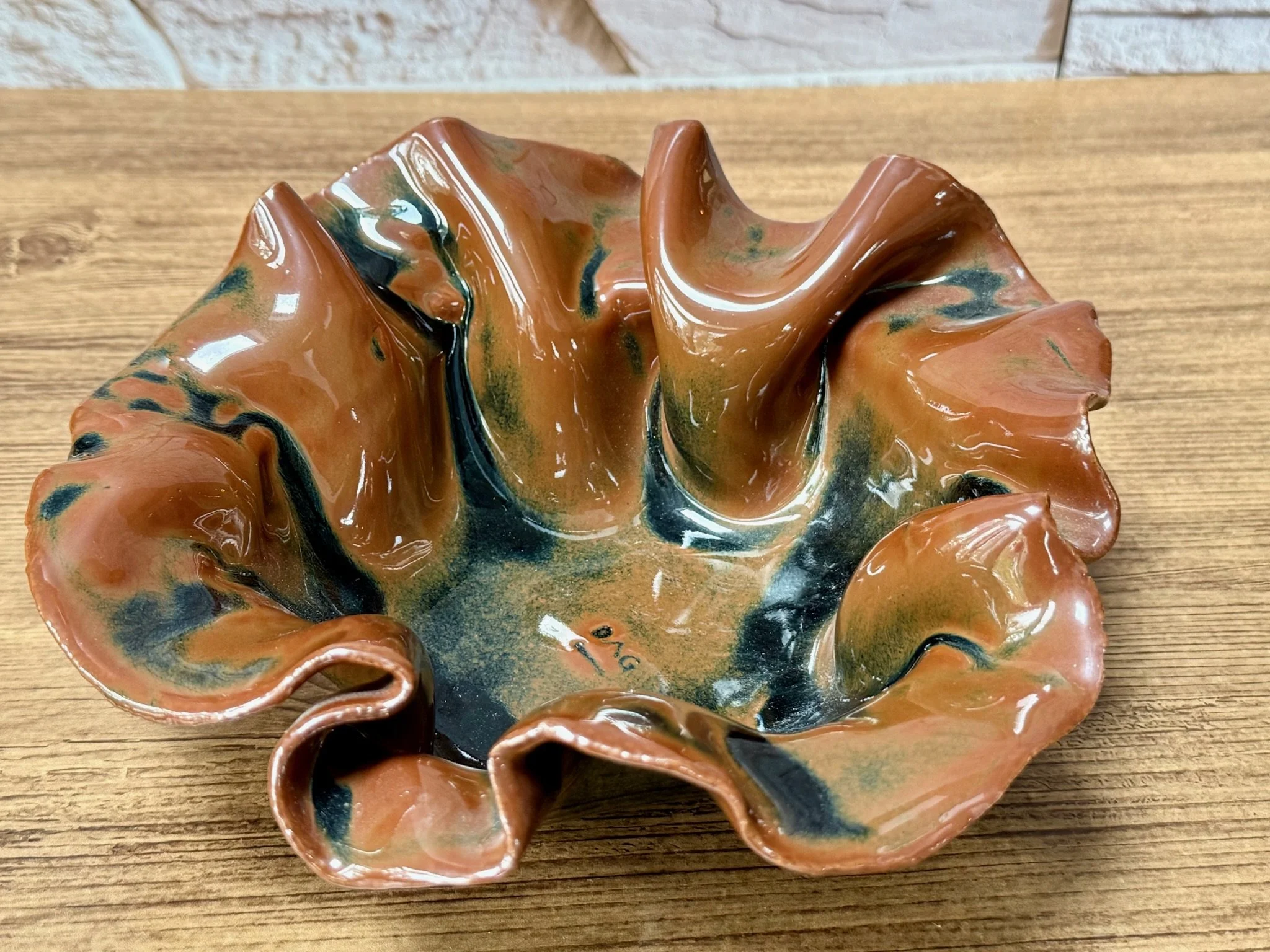 Wide white stoneware bowl with rich rust glaze and warm reduction tones.