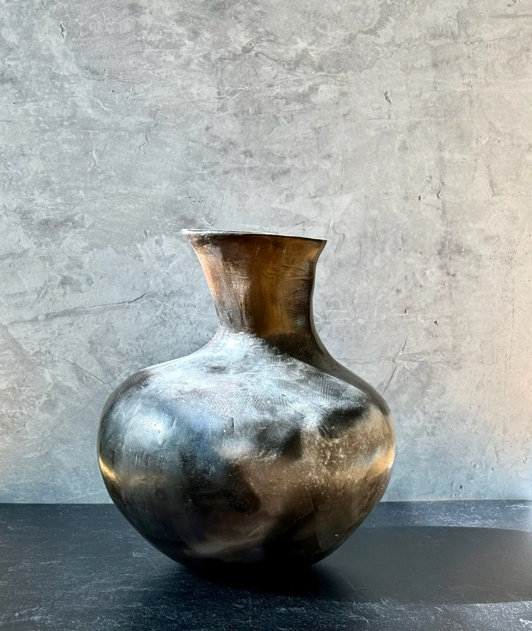 Large white stoneware vase with matte terra sig surface and smoke-fired markings.