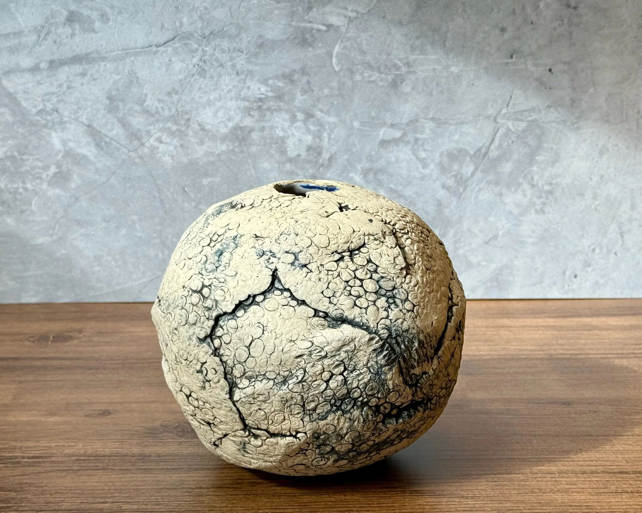 Rounded moon vase with cobalt oxide brush accents and clean fired finish.