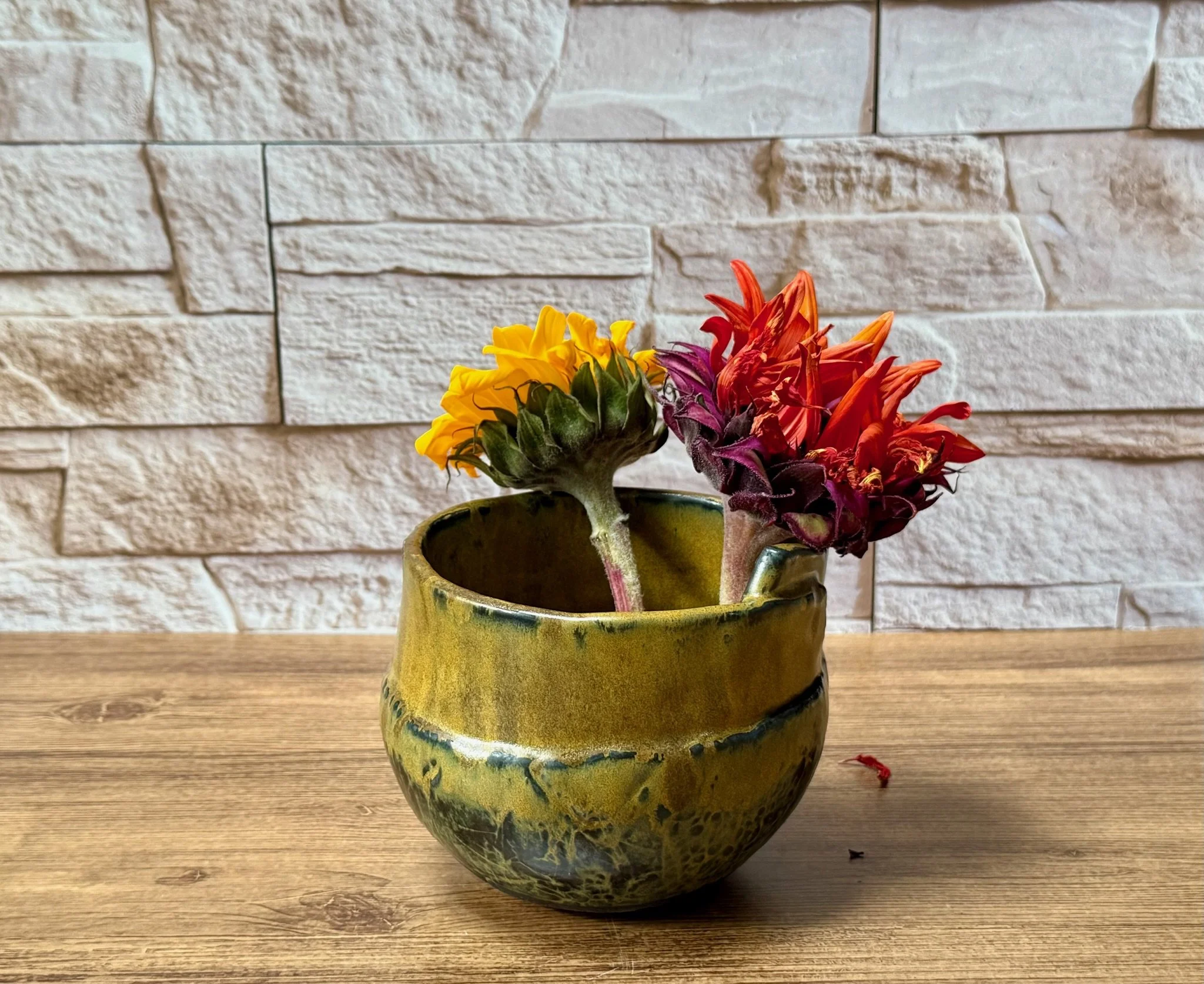 Small two-tone bowl with deep red over black matte glaze and crisp profile.