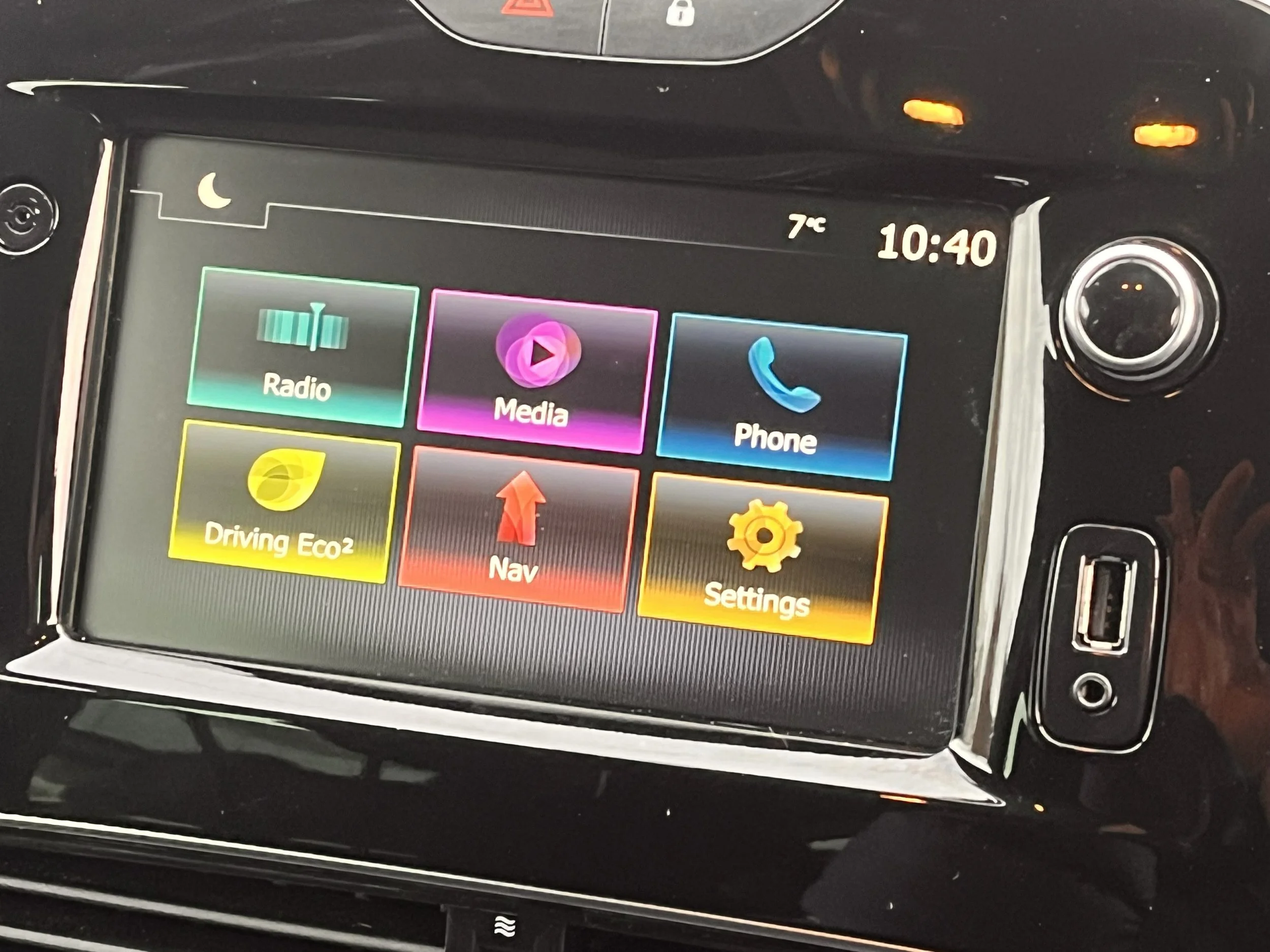Car dashboard touchscreen showing options for Radio, Media, Phone, Driving Eco2, Nav, and Settings, with the time 10:40 and temperature 7°C.