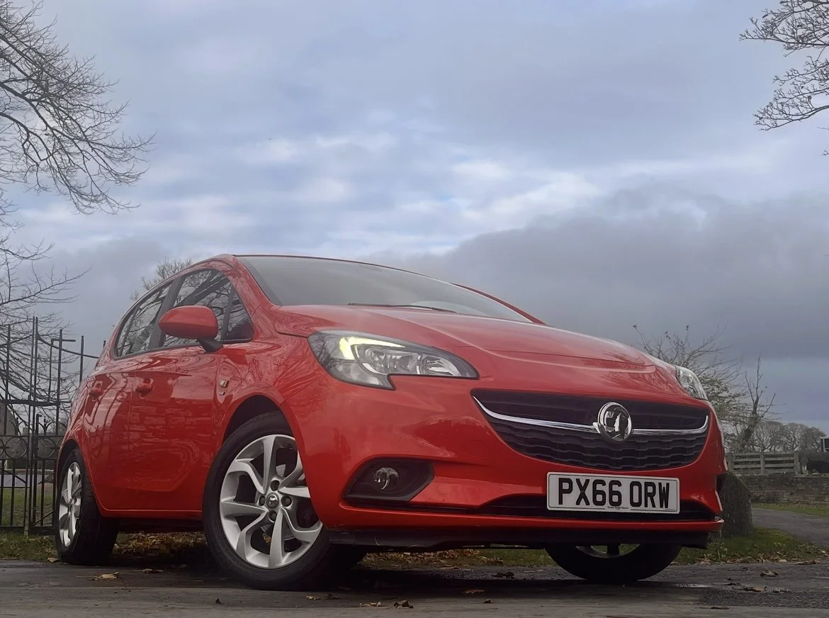 A red Vauxhall Astra hatchback parked outdoors on a cloudy day.
