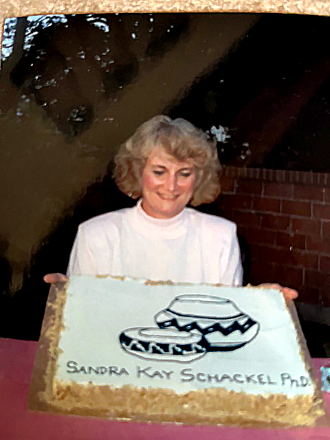 Sandra Schackel with cake celebrating her PhD.