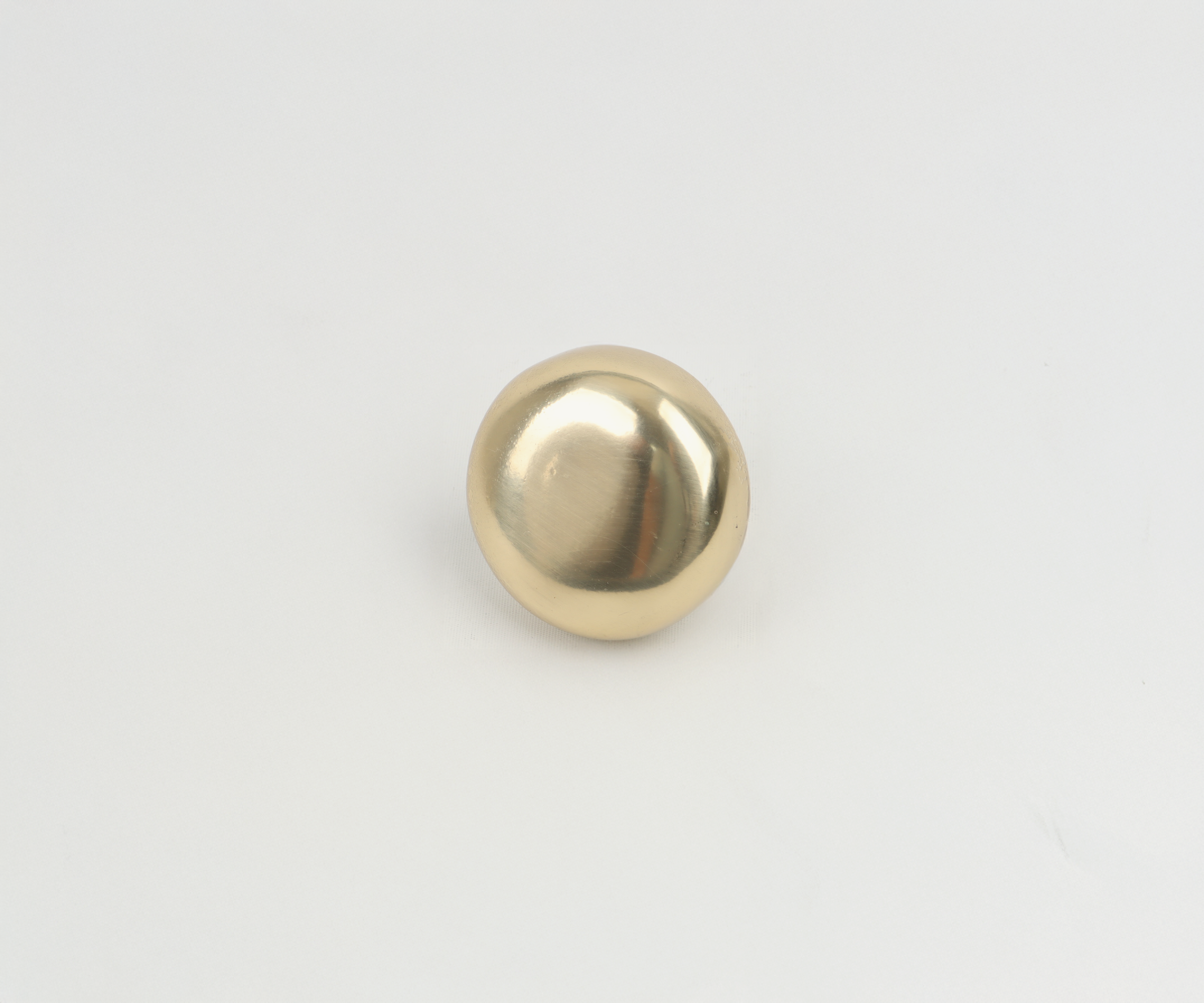 Gold metallic sphere on a white background.