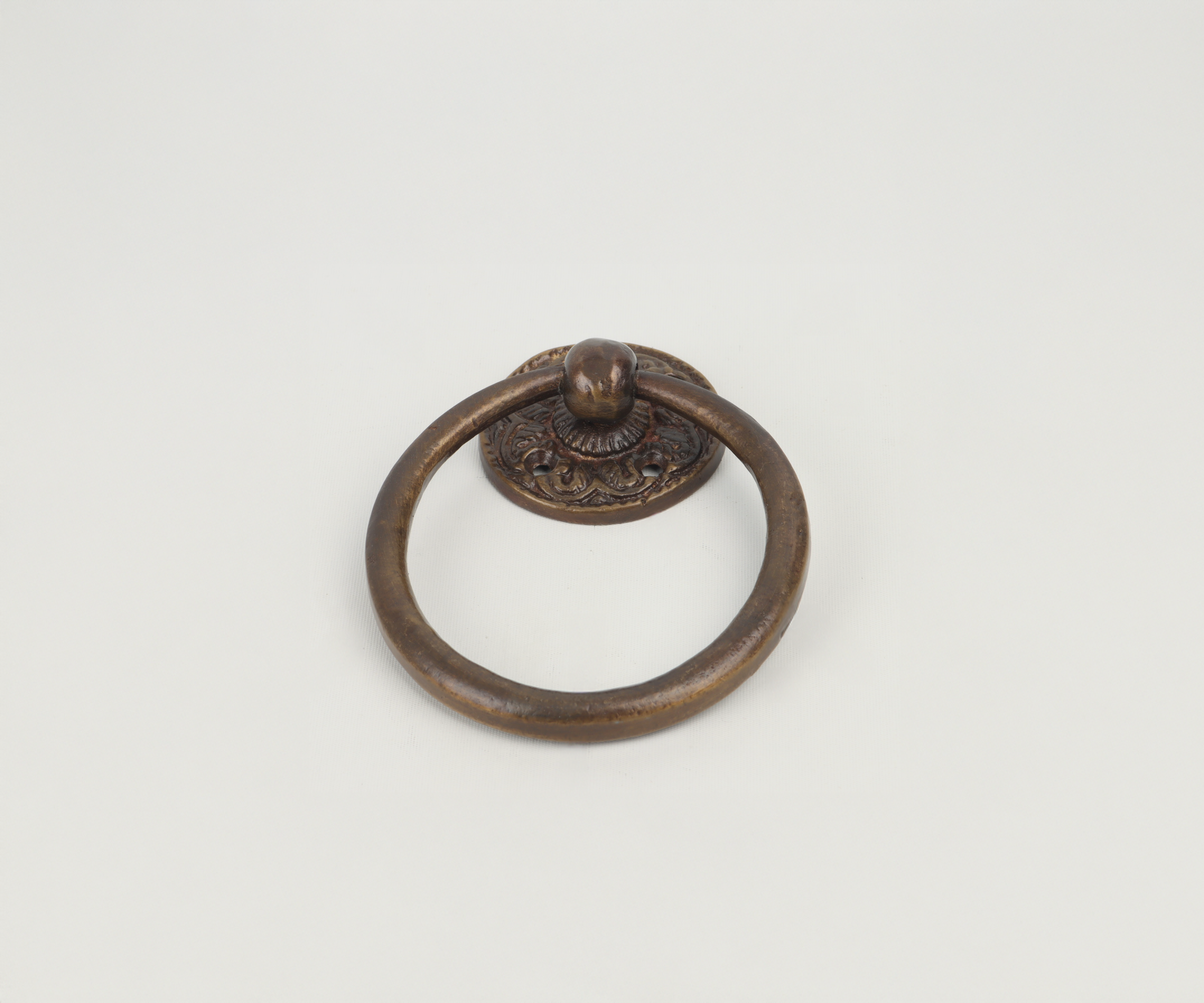 Antique bronze door knocker on a white background