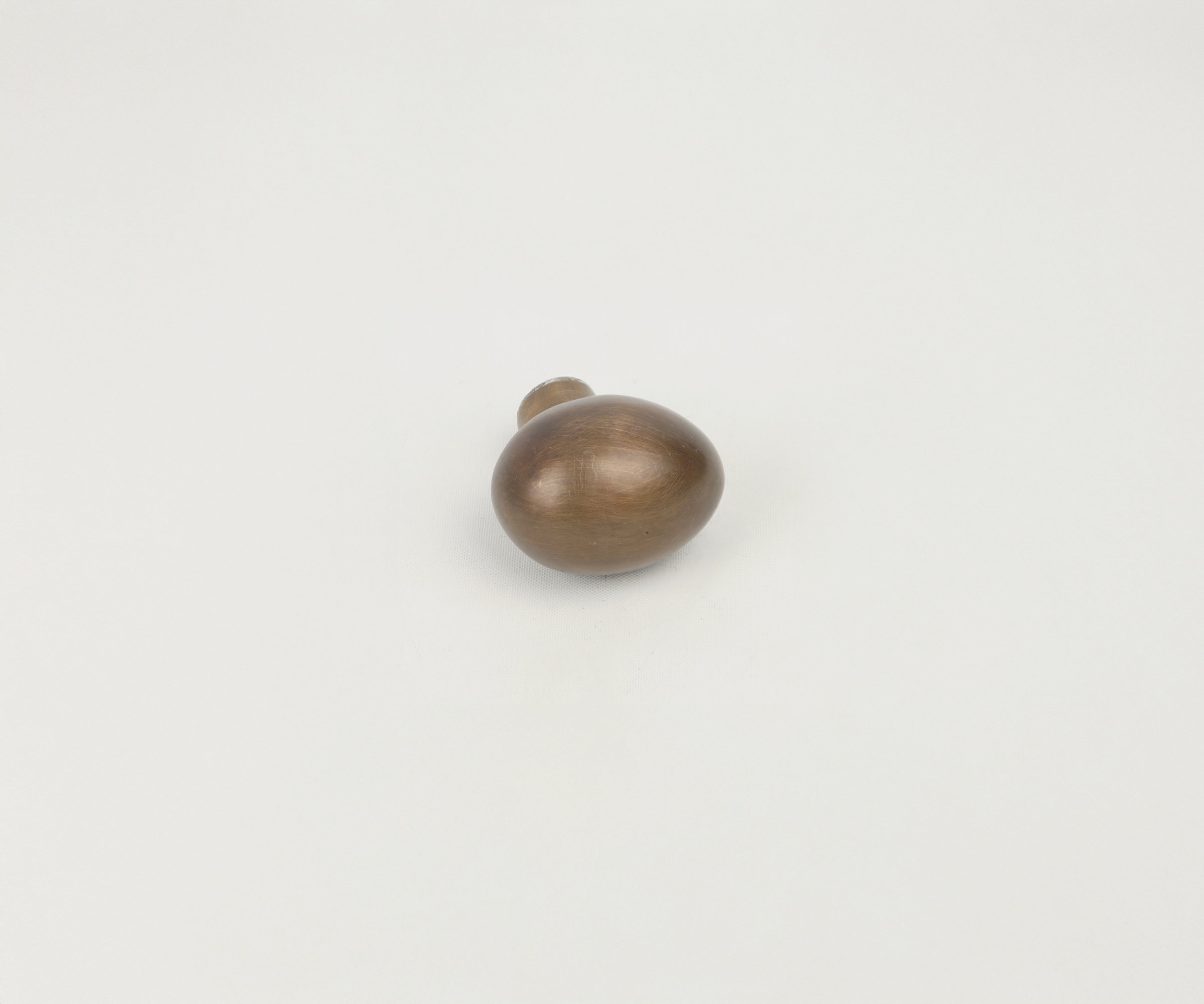 Single wooden sculpture resembling a rounded, irregular shape, placed on a plain white background.