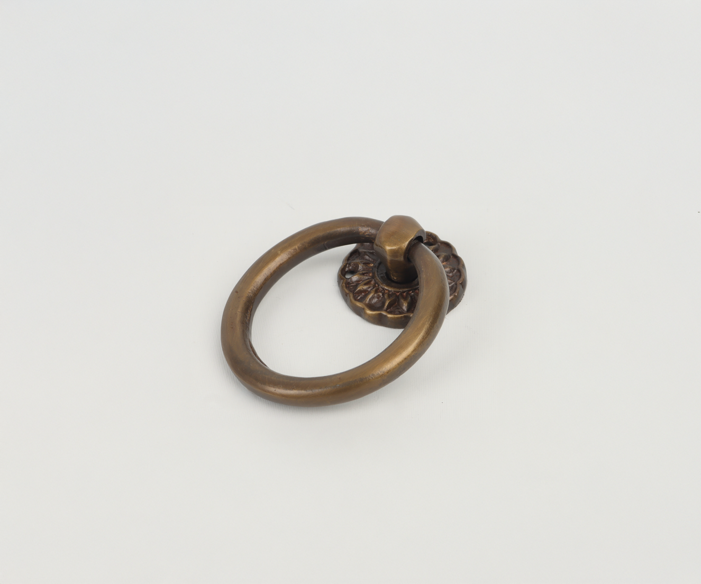 Bronze door knocker with a circular ring on a white background.