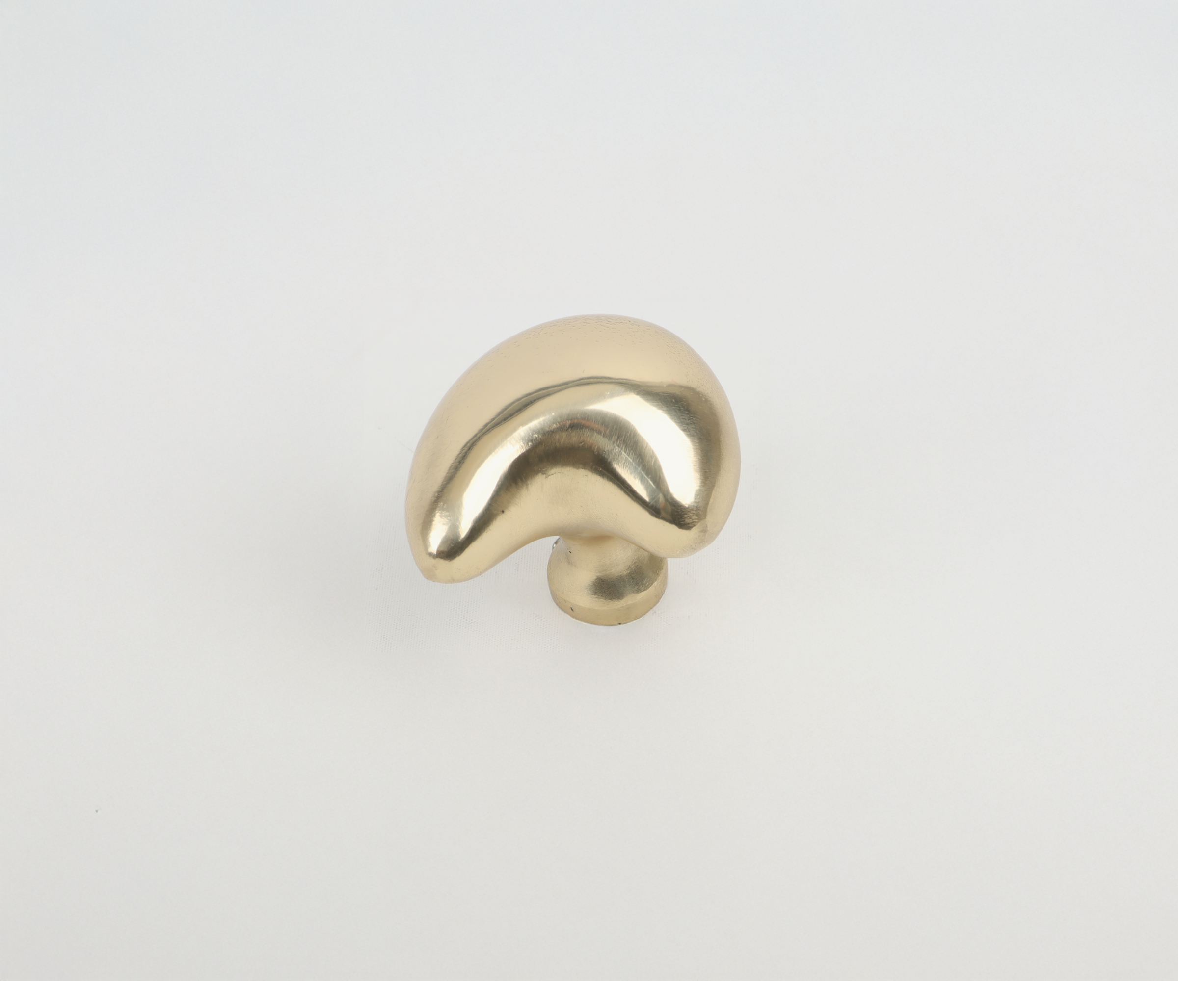 A small metallic mushroom-shaped sculpture with a shiny gold finish on a plain white background.