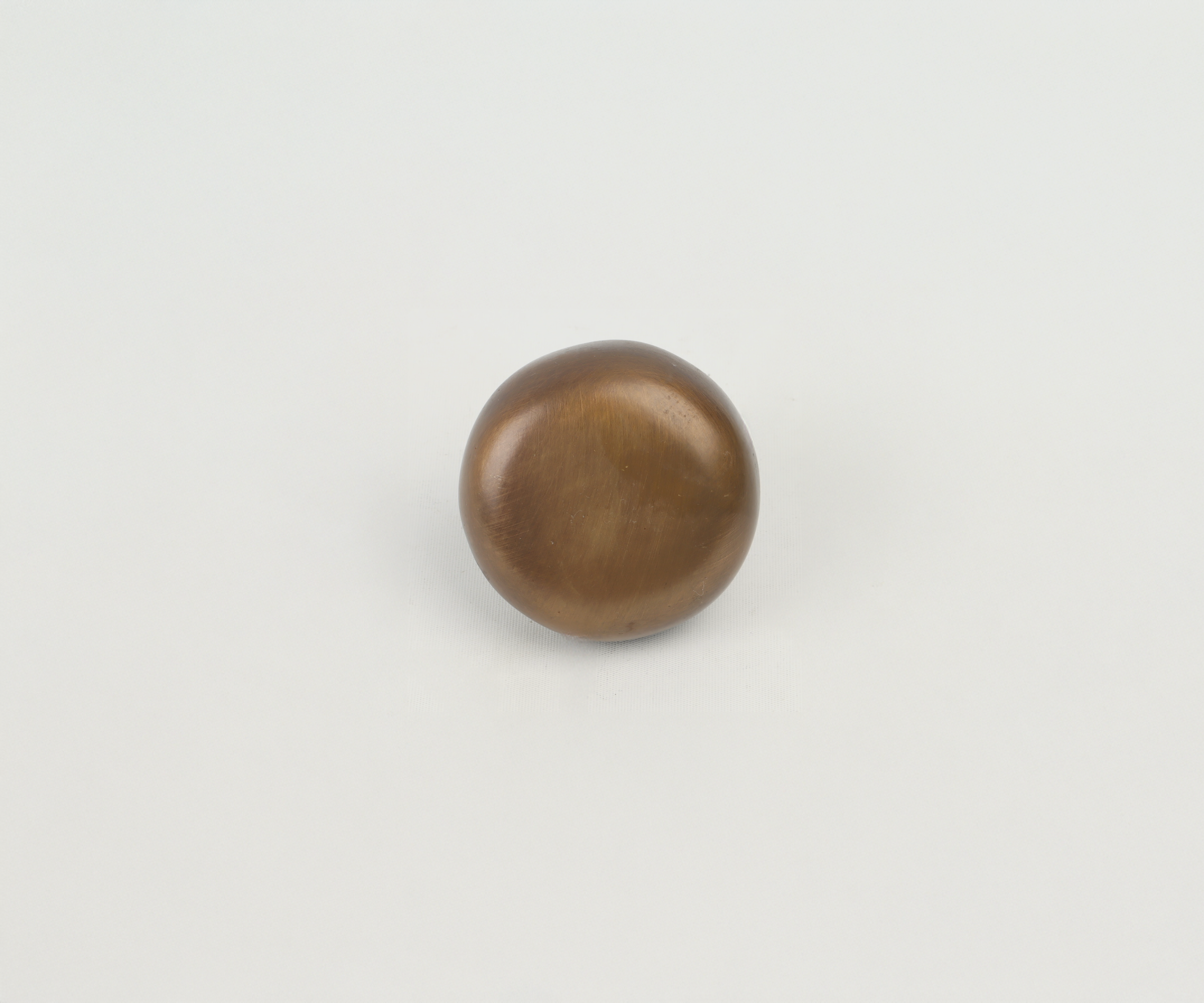 Brown metallic spherical object on white background
