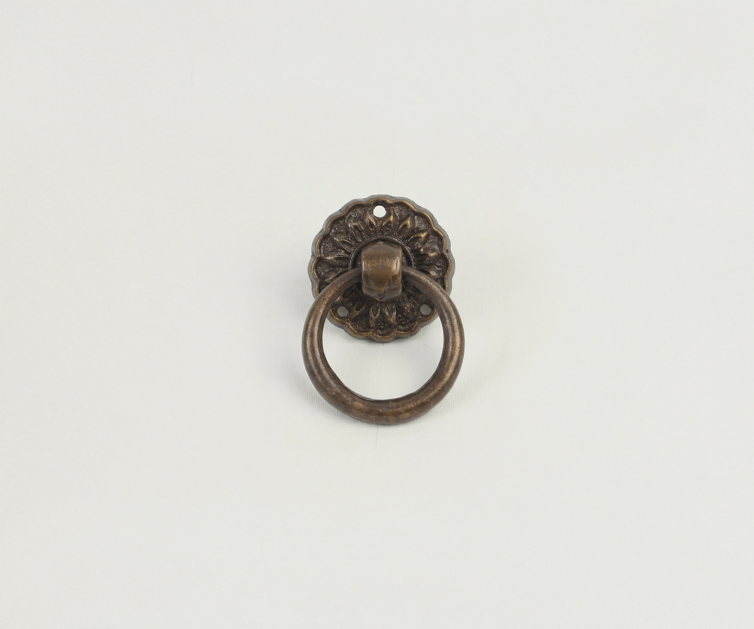 Antique bronze door knocker on a plain white background.