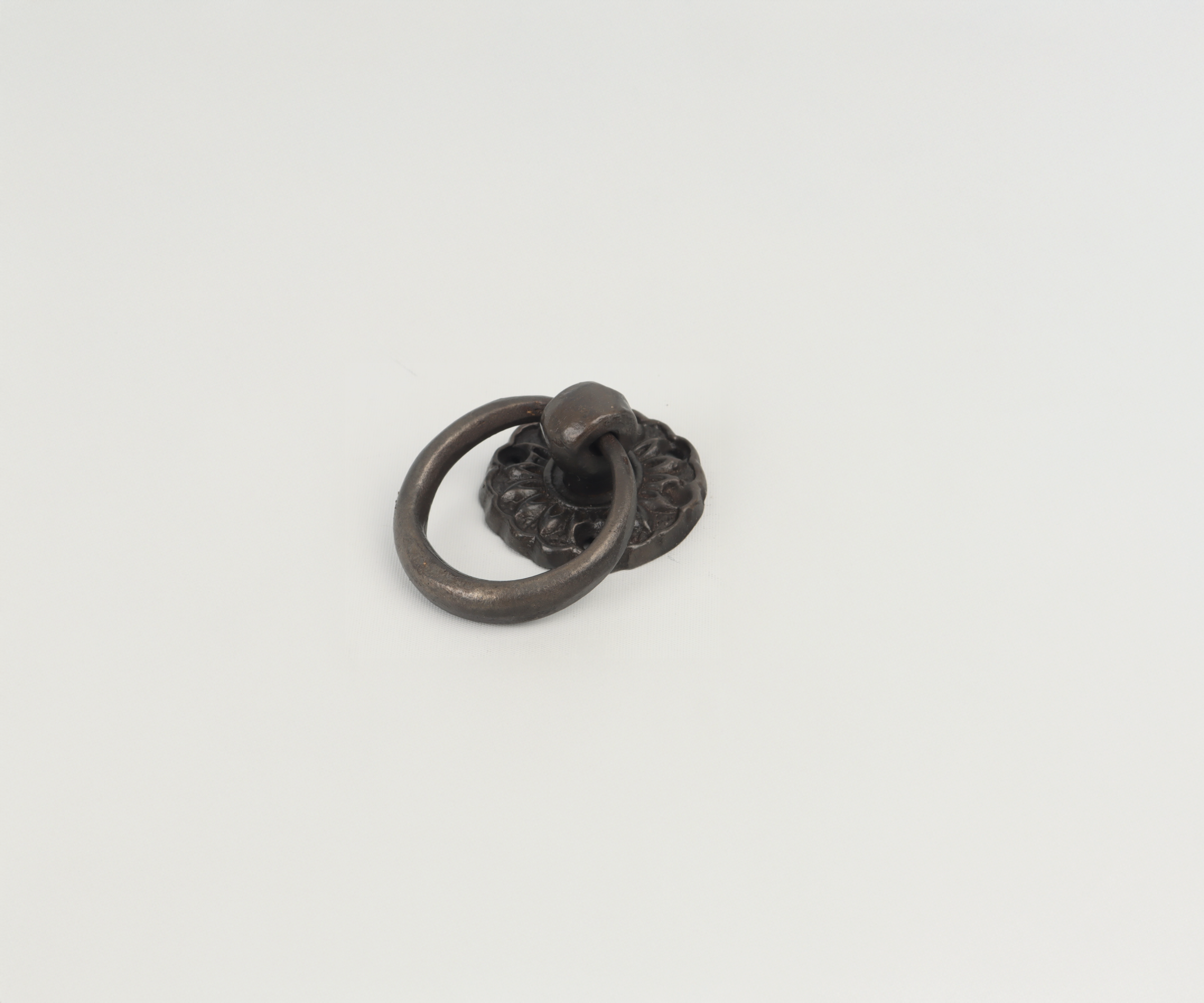 Metal door knocker with circular ring on white background.