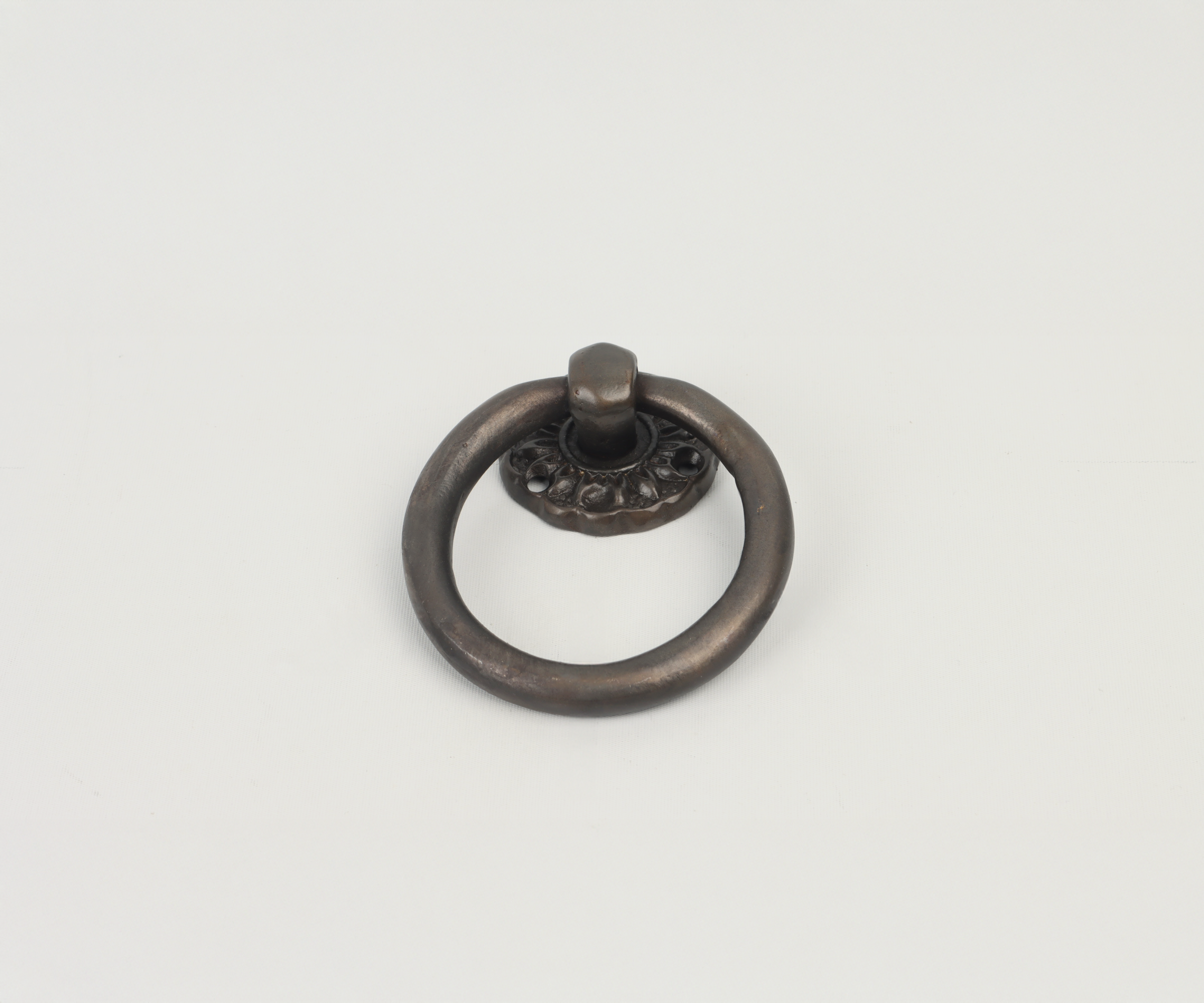 Old-fashioned metal door knocker on a blank white background.