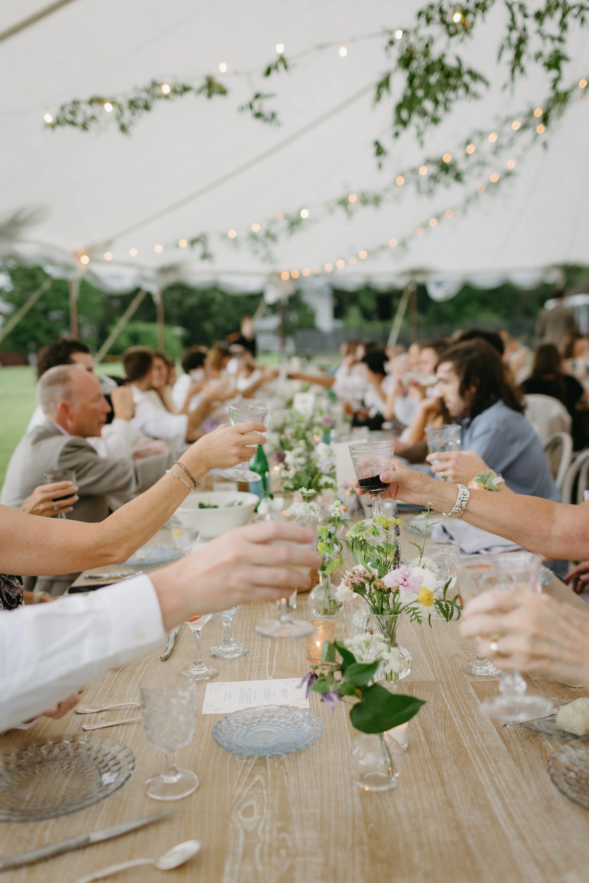 Photo of people gathering around a floral centerpiece