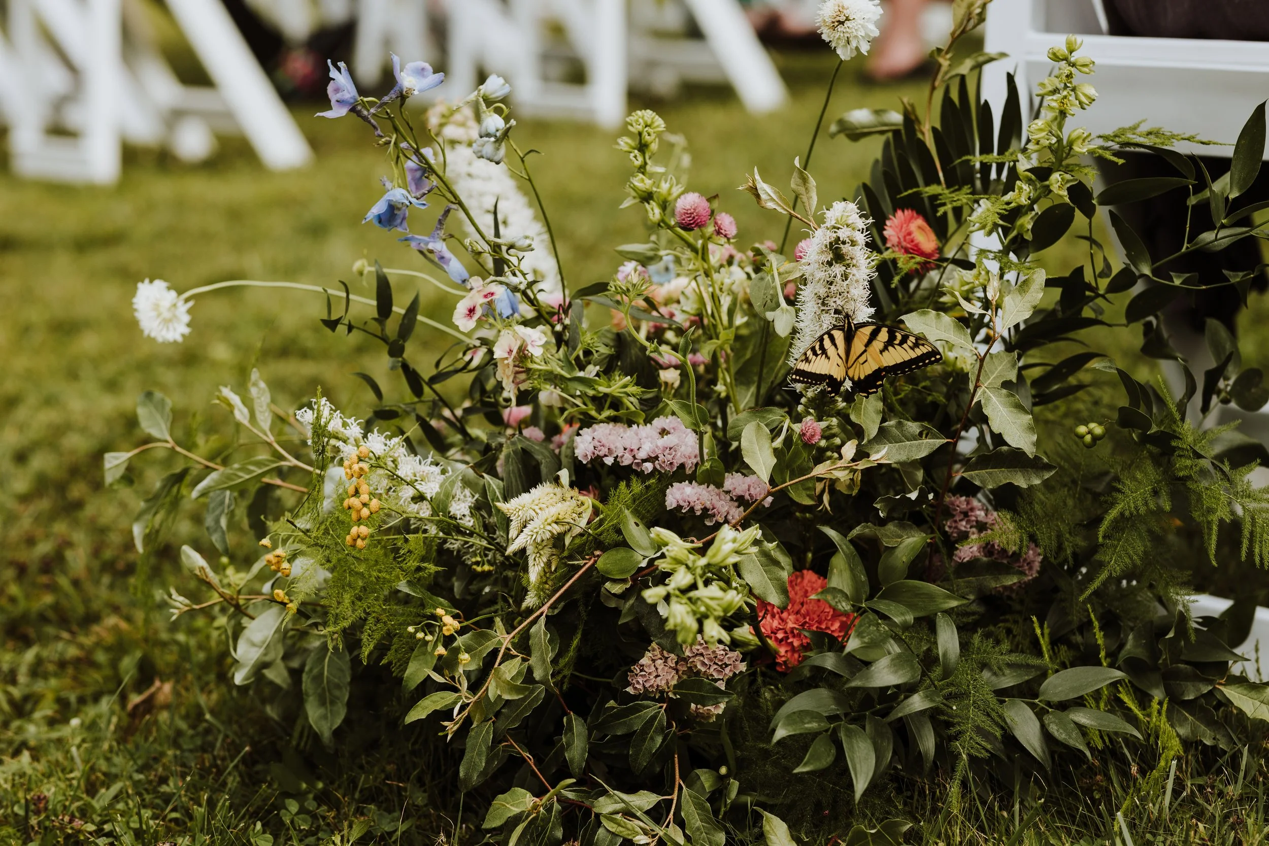 Lush floral arrangement with a yellow butterfly, photo by Graceful Fawn Photography