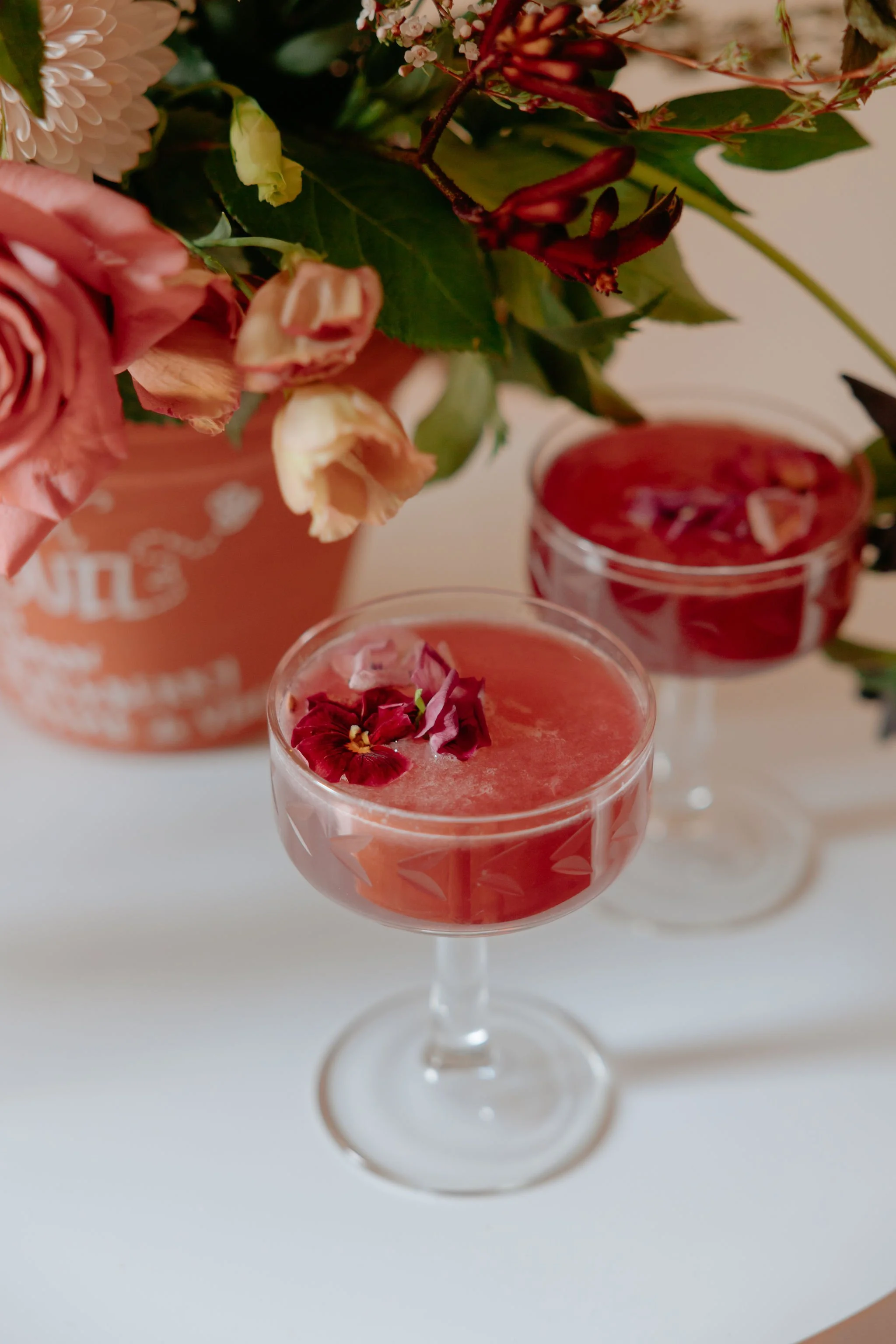 Photo of flowers styled in a cocktail for a brand shoot. Photo by Liz Capuano Photography