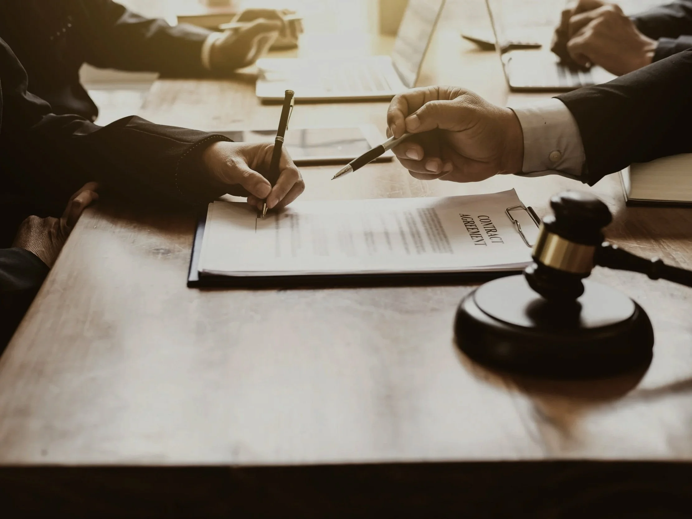 Empty courtroom with wooden furnishings, judge's bench, and seating area