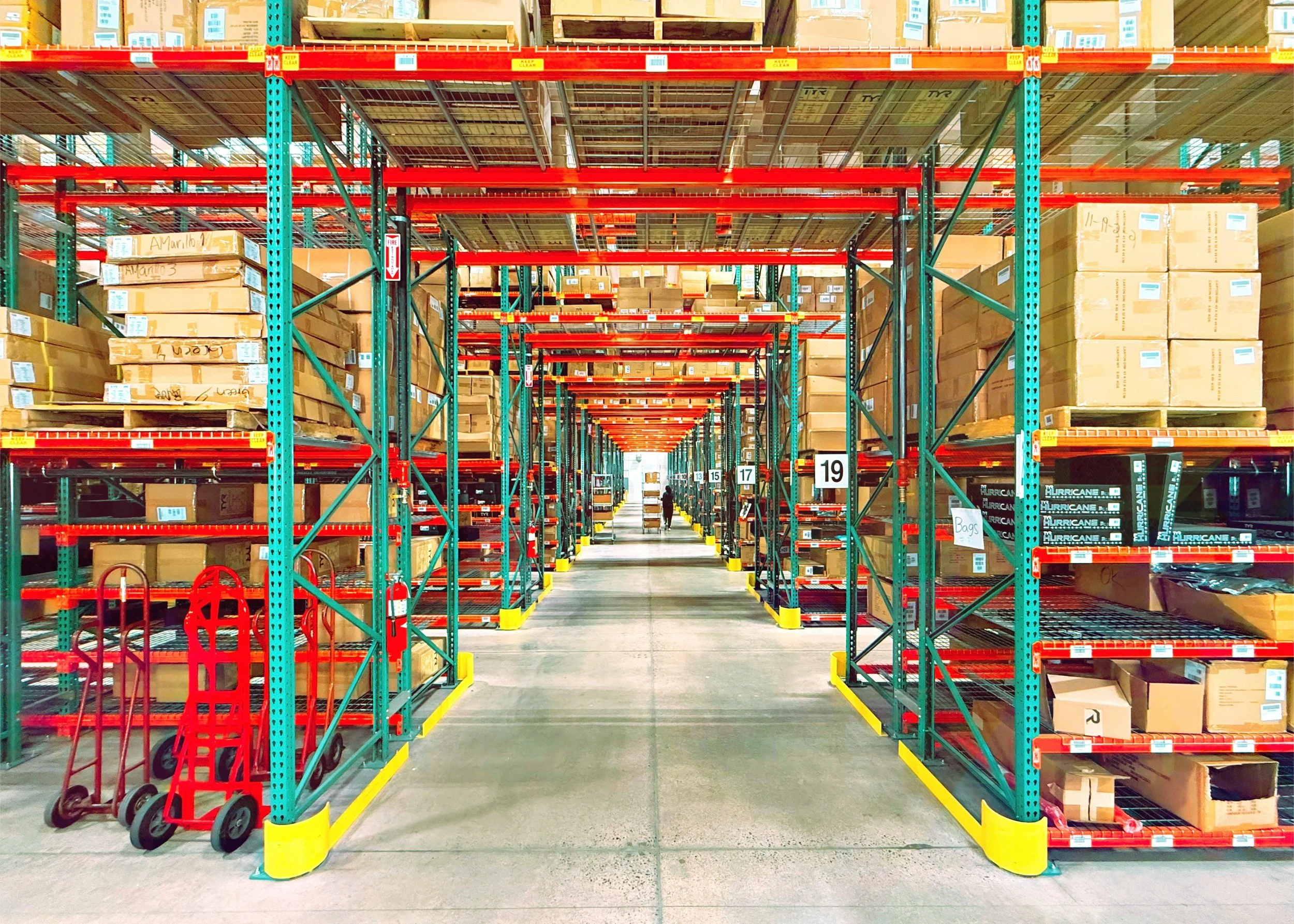 Large organized warehouse with pallets, barcode scanners, or inventory management