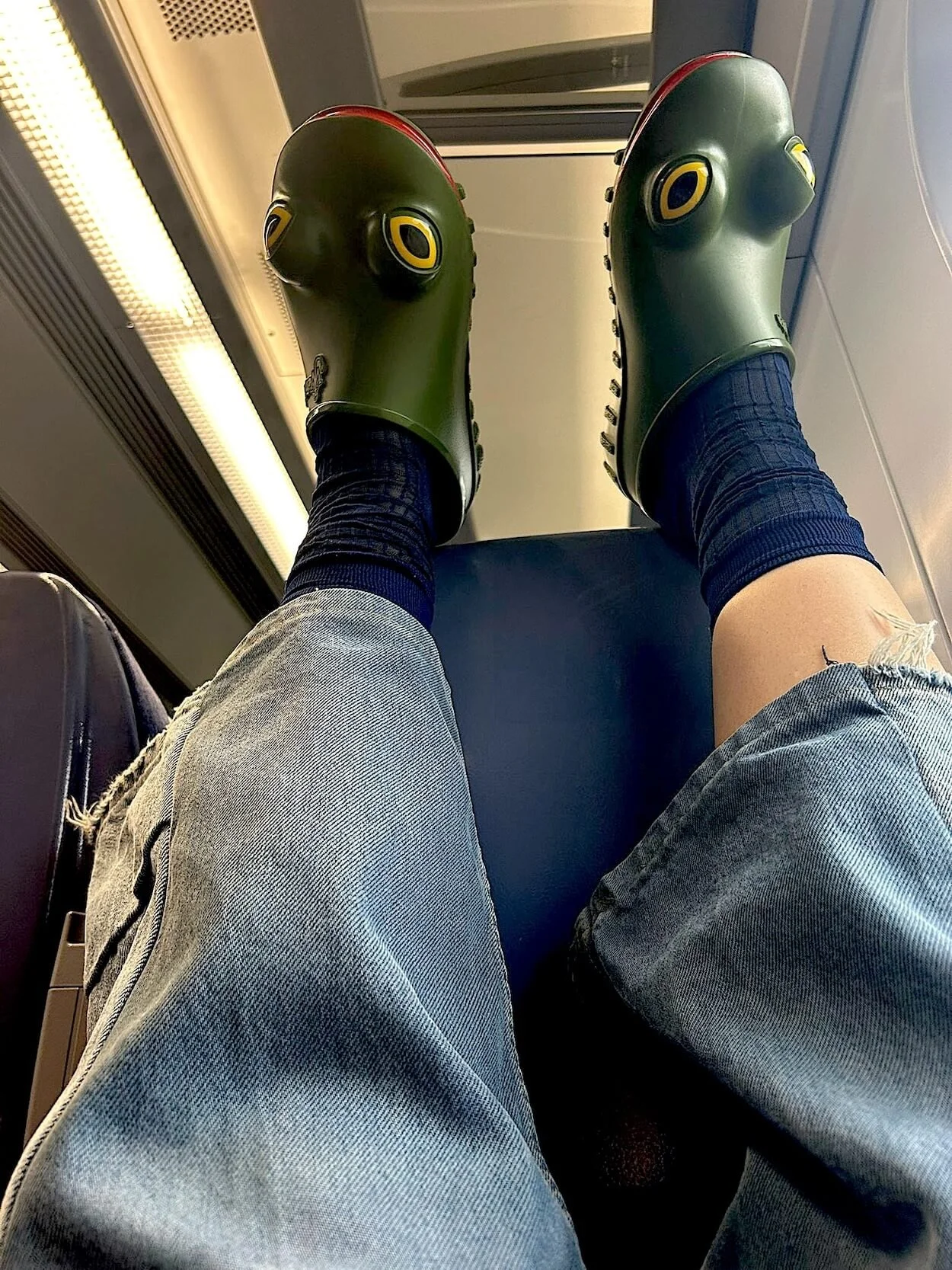 Alexandra Mann wearing green rubber frog shoes, photographed by Alex and sent after a conversation about 'froggy toes'.